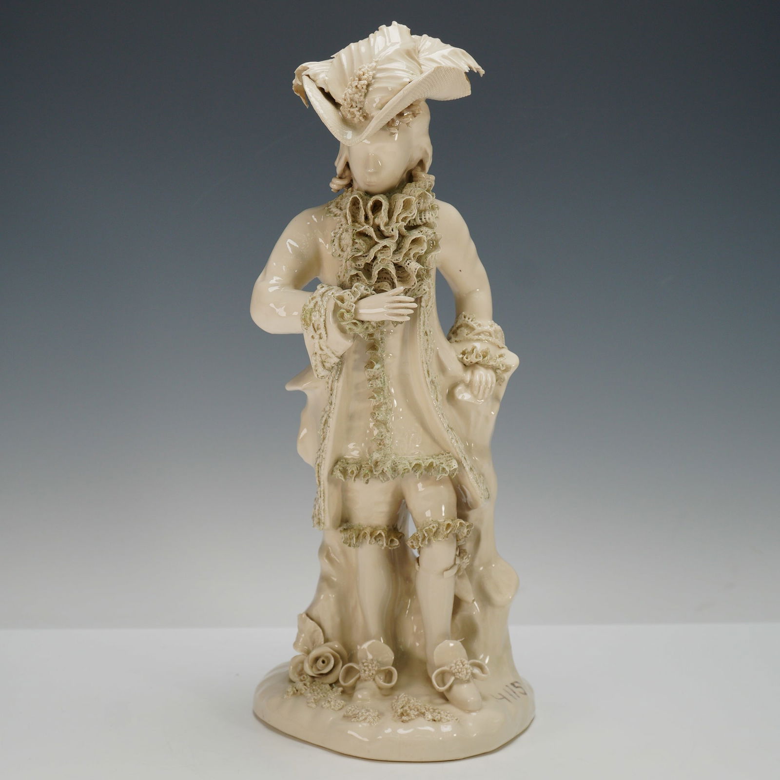 Cordey Bisque Porcelain Figurine, Octavio 4072: This finely crafted porcelain figurine depicts a gentleman in 18th-century attire, adorned with an elaborate feathered hat, ruffled cravat, and lace-trimmed coat. The piece is characterized by Cordeys
