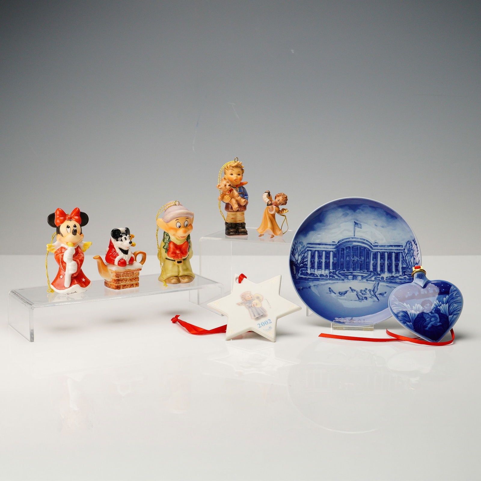 8pc Christmas Figurines & Ornaments, Hummel & Disney: This charming 8-piece assortment of Christmas collectibles includes festive figurines and ornaments by beloved makers such as M.I. Hummel and Walt Disney. Featured are Minnie Mouse in a holiday gown a