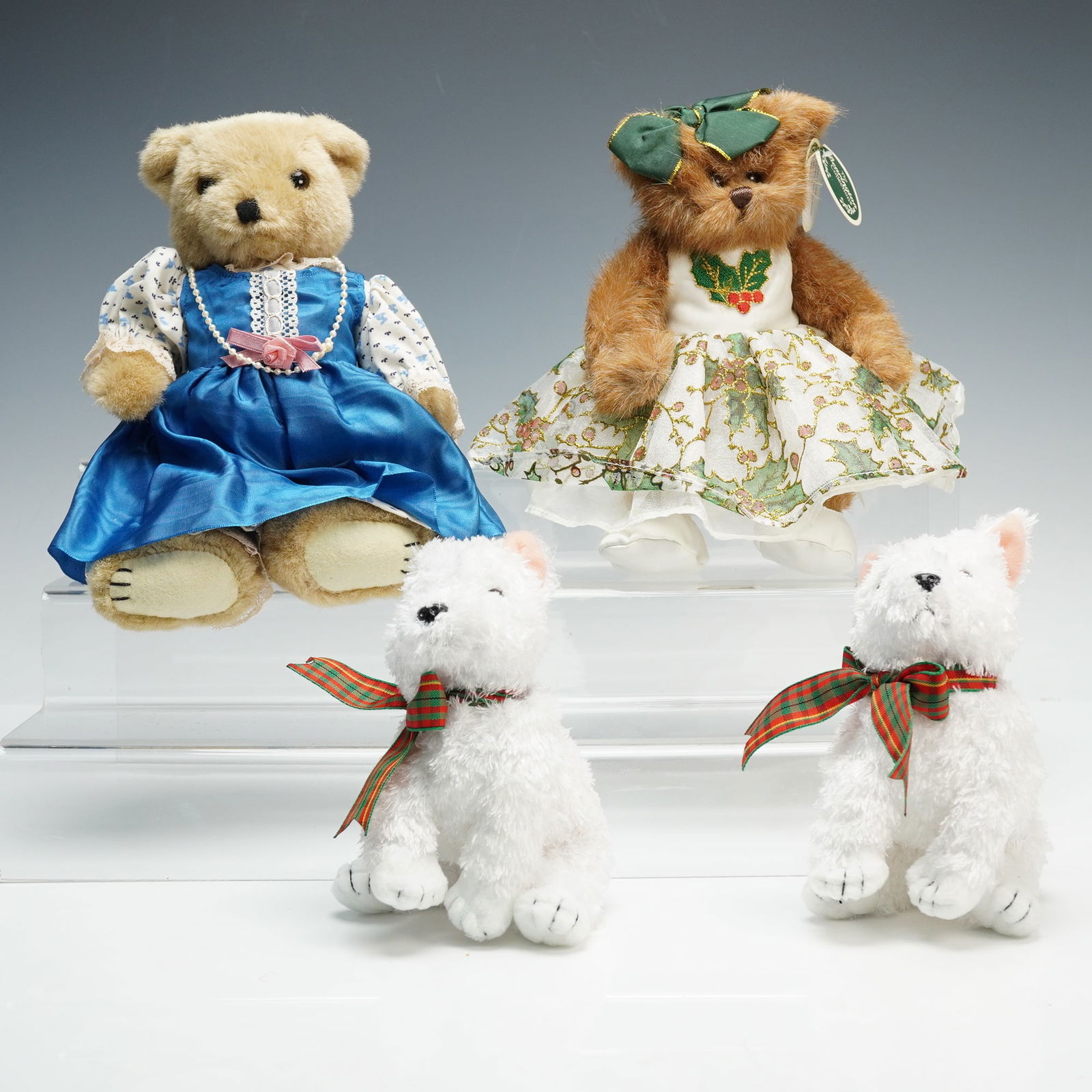 4pc Plush Bear and Terrier Toy Collection: This 4-piece group includes one Bearington Collection Hollyday Dancer bear in green and gold holly-patterned dress, one plush bear in blue satin dress with lace trimmed sleeves and wearing a pearl nec