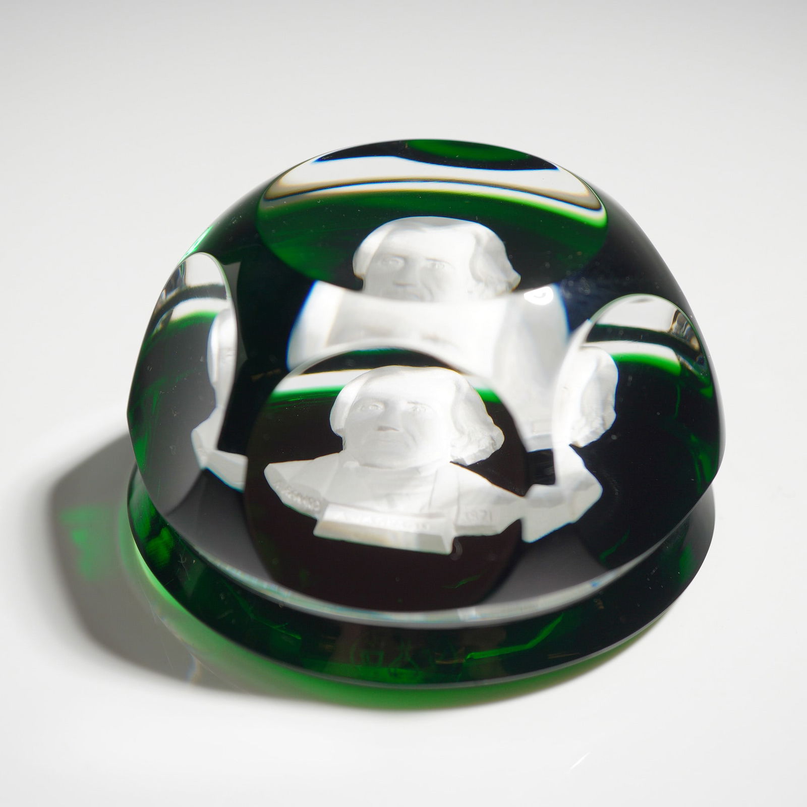 Baccarat Crystal Sulfide Paperweight, Andrew Jackson: The piece features a white cameo bust of Andrew Jackson encased within faceted emerald green and clear glass. The interior bust is inscribed A. JACKSON and dated 1971. The faceted dome is constructed
