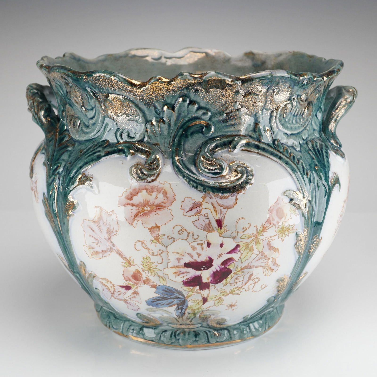 French Hand Painted Gilt and Teal Limoges Porcelain Jardiniere: A single French Hand Painted Gilt Limoges Porcelain jardiniere or cachepot. The item features a bulbous body and a scalloped rim, executed in high relief molding. The decoration is applied over a whit