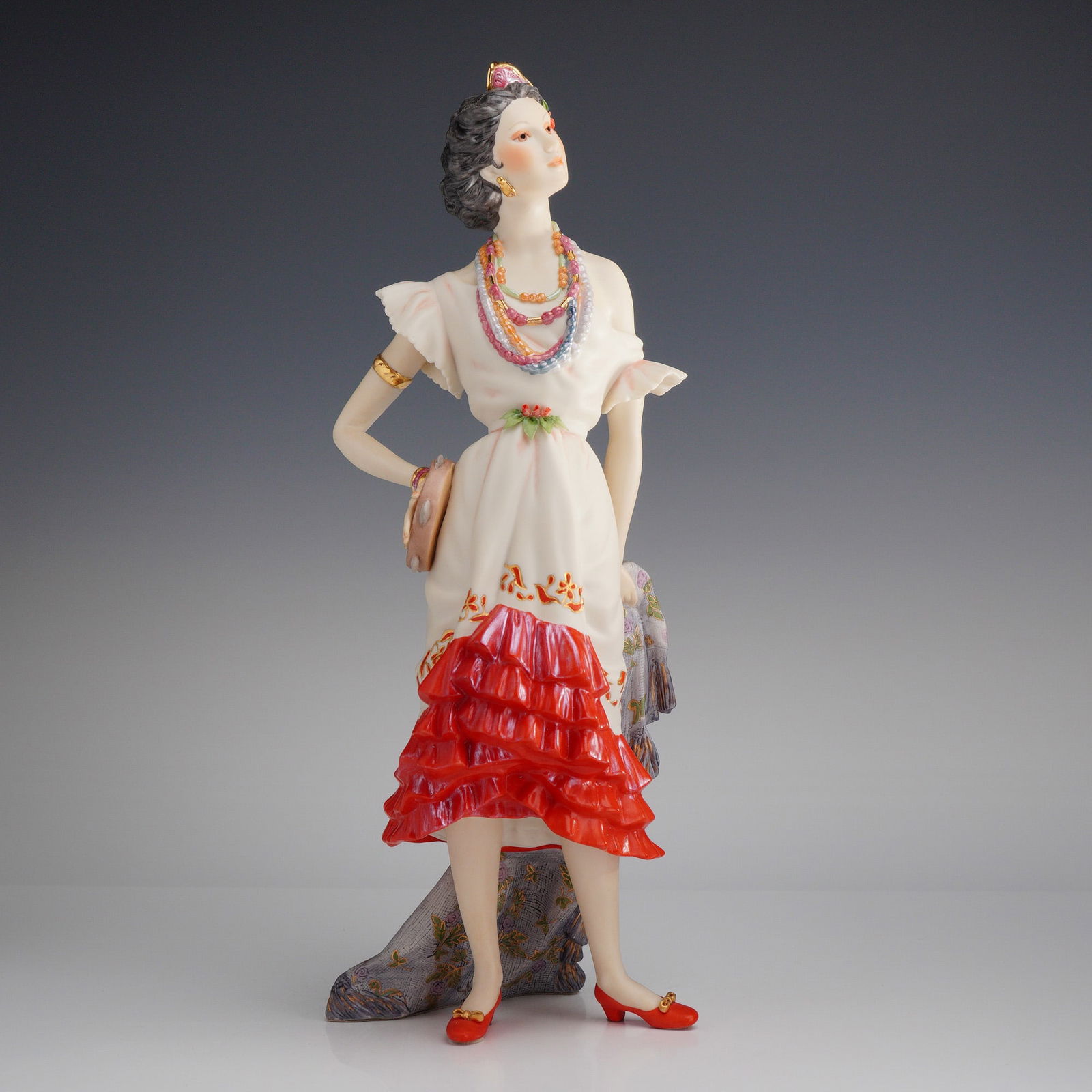 Cybis Porcelain Sculpture, Carmen: A hand-painted bisque porcelain figurine produced by Cybis as part of the Music and Opera collection. The polychrome figure is depicted in traditional Spanish attire, featuring an off-the-shoulder whi