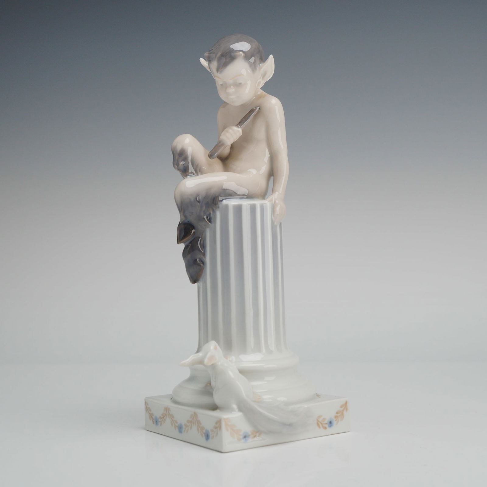 Royal Copenhagen Porcelain Figurine, Faun with Rabbit No. 456: A Royal Copenhagen glazed porcelain figurine depicting a mythological faun with rabbit 456. The figure is portrayed as a pan or faun seated atop a fluted classical column while playing a flute. A smal