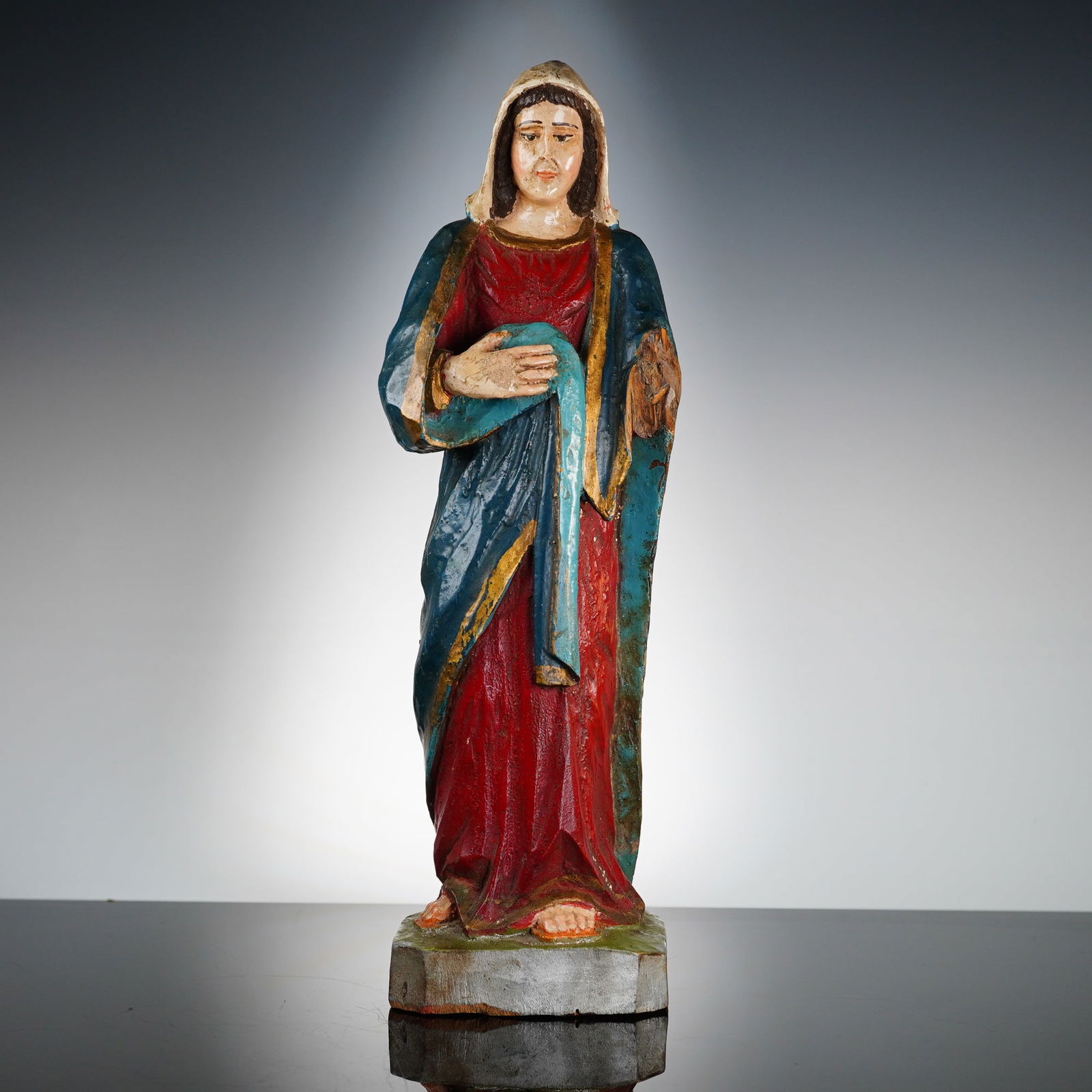 Mid-Century Carved Wood Virgin Mary Devotional Figurine: This polychrome carved wood devotional figure depicts the Virgin Mary and is of Latin American origin, dating from the early to mid 20th century. The figure is rendered in a folk art style and stands