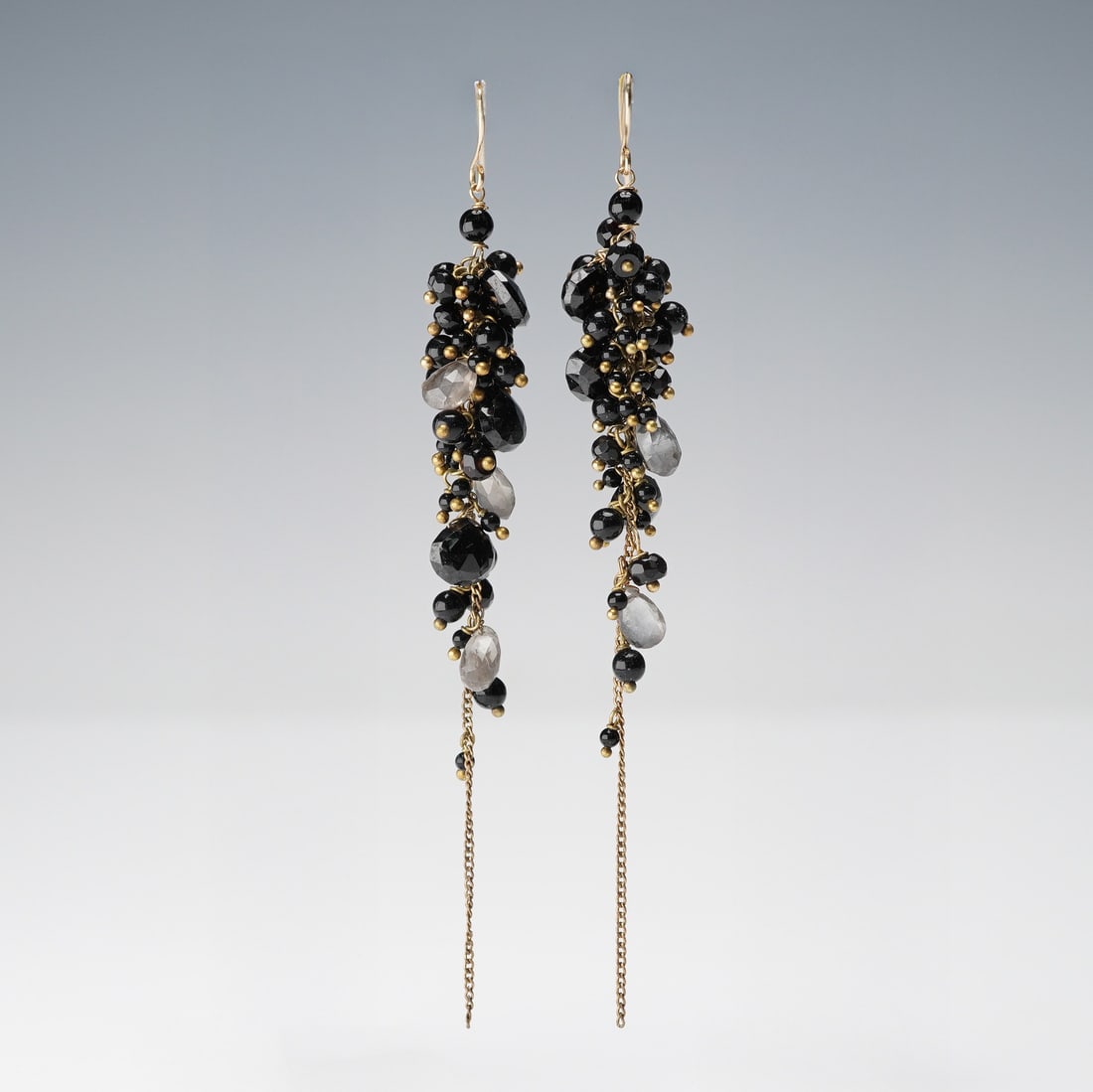 Pair of 14K Gold Dangle Earrings with Black and Smoky Quartz Faceted Beads: A pair of contemporary-style 14K gold tested dangle earrings with black and smoky quartz beads, accented with gold-tone elements. Each earring features a clustered arrangement of beads attached to ear
