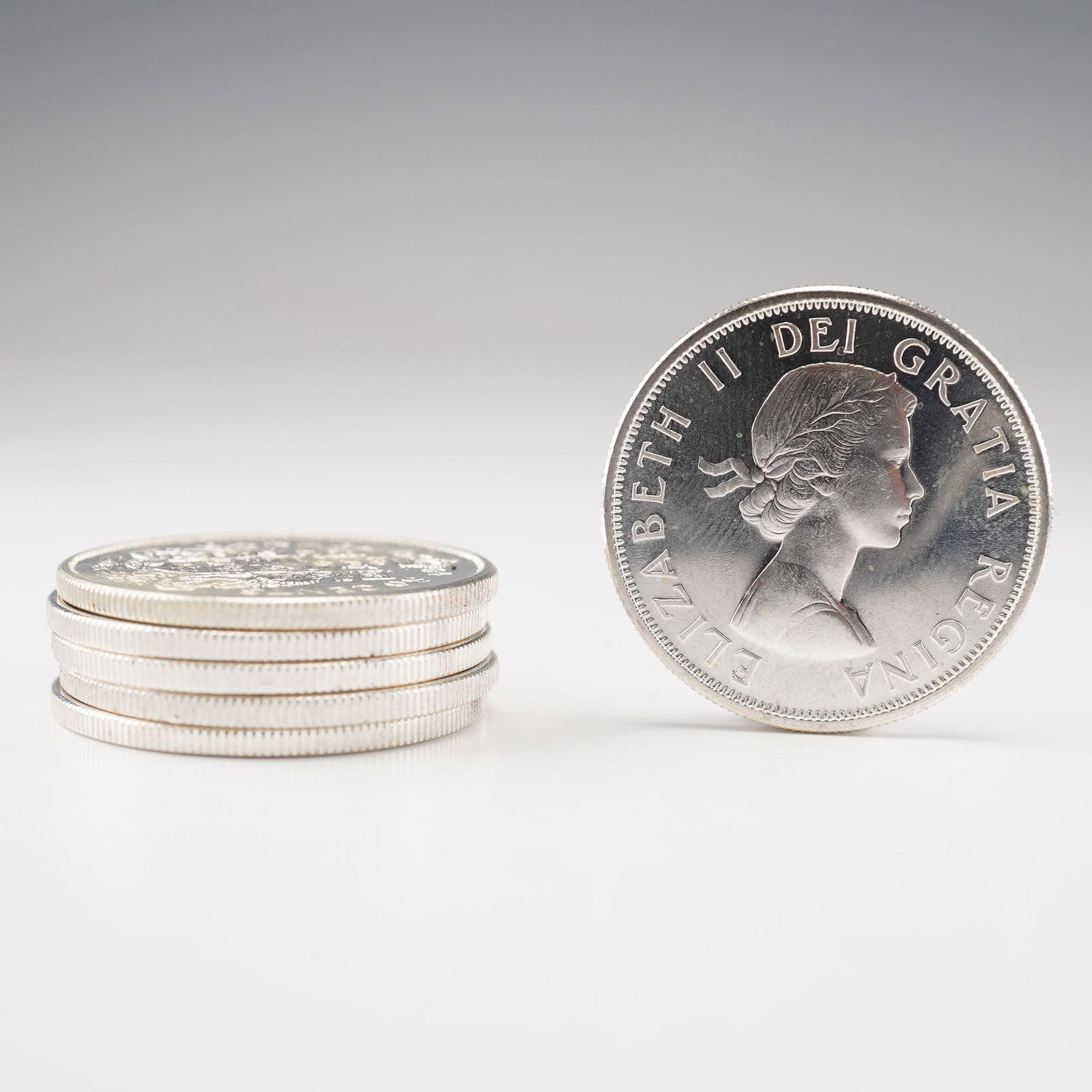 6pc 1964 Canada Elizabeth II 50 Cent Coins: Each composed of 80% silver, the obverse bears the young portrait of Elizabeth II, surrounded by ELIZABETH II DEI GRATIA REGINA. The reverse depicts a crown dividing the date above the Royal Arms of