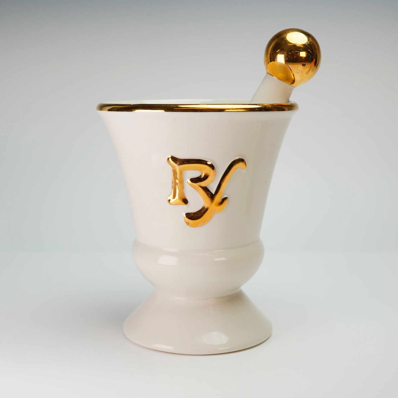 Owens-Illinois Porcelain Apothecary Mortar and Pestle Advertising Set: This Owens-Illinois porcelain apothecary mortar and pestle set was produced as a pharmacy advertising display. The two-piece set is constructed of glazed white ceramic. The mortar is designed with a