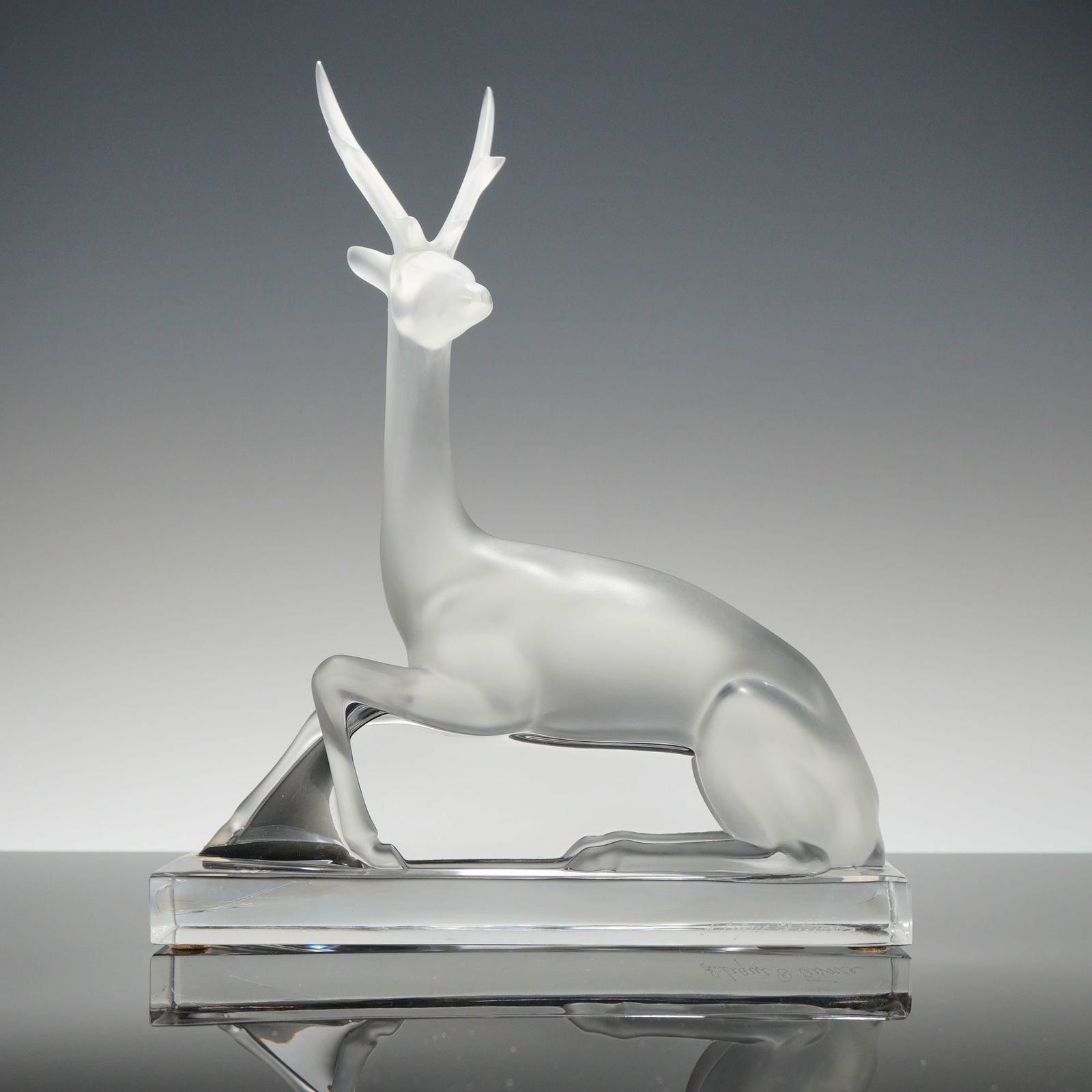 Lalique Frosted Crystal Cerf Deer Stag Figurine: This Lalique crystal figurine, identified as the Cerf or stag, is a French frosted and clear crystal sculpture. The design features a reclining deer with its head turned upward and elongated antlers,