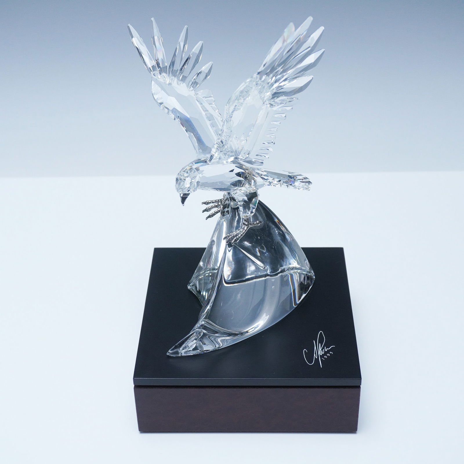 Swarovski Crystal LE Sculpture, The Eagle + Signed Base: A magnificent Swarovski limited edition crystal sculpture, The Eagle - King of the Air, depicting an intricately detailed eagle in mid-flight with wings spread wide, poised over a sleek, crystal wave