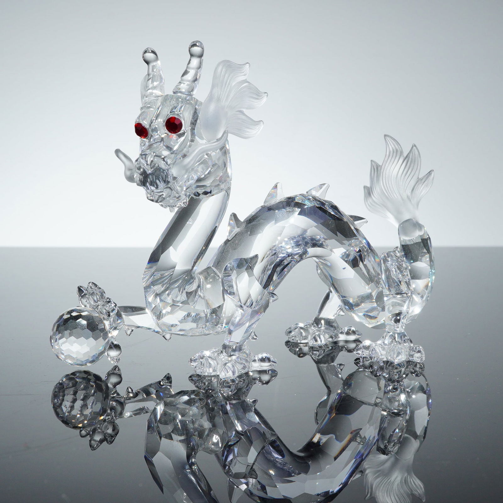 Swarovski Crystal Society 1997 Annual Edition, The Dragon Figurine: A Swarovski Crystal Society (SCS) Annual Edition figurine titled The Dragon, part of the Fabulous Creatures series released in 1997. This Asian-style dragon is constructed from clear faceted crystal w