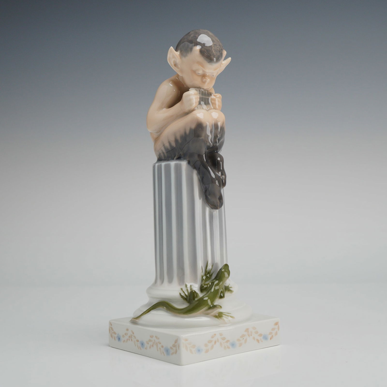 Royal Copenhagen Porcelain Figurine, Faun with Lizard 433: A Royal Copenhagen glazed porcelain figurine, model number 433, titled Faun with Lizard on Column and attributed to designer Christian Thomsen. The figure depicts a mythical faun seated atop a fluted