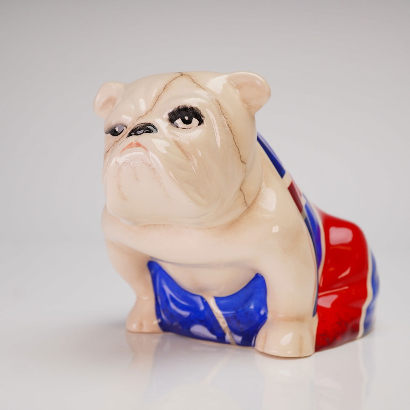 Royal Doulton Spectre 007 Jack the Bulldog DD007M Figurine: A Royal Doulton Spectre 007 Jack the Bulldog figurine. The figurine, identified by the DD007M designation, is executed in glazed earthenware or porcelain, depicting the seated bulldog "Jack" draped in