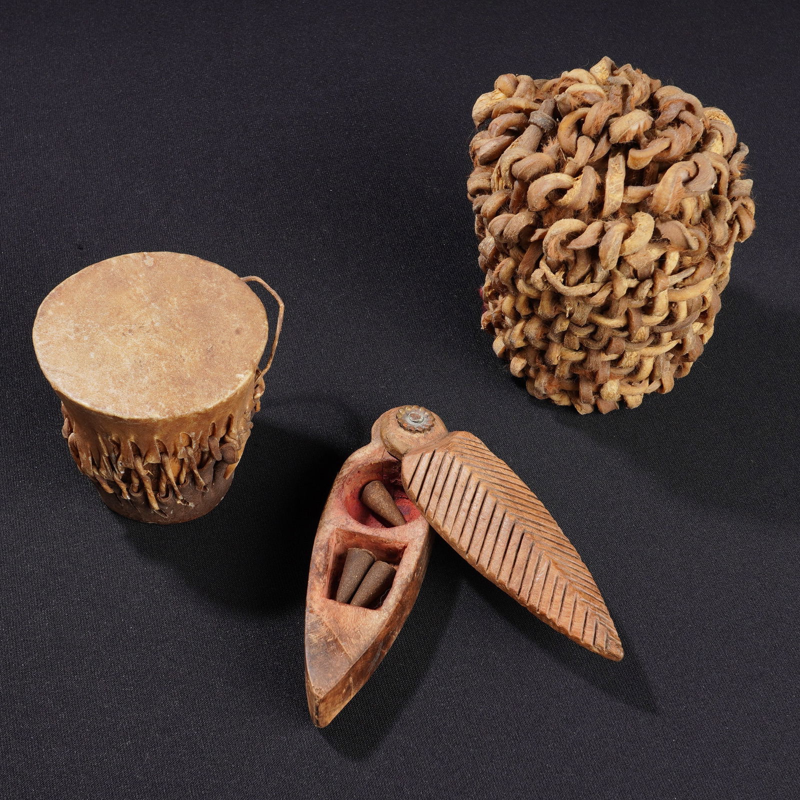 3pc Ethnographic Folk Art Objects: A three-piece lot of handcrafted ethnographic objects. The group includes a small African leather drum featuring an animal hide head secured with skin lashings over a dark wood base. Also included is