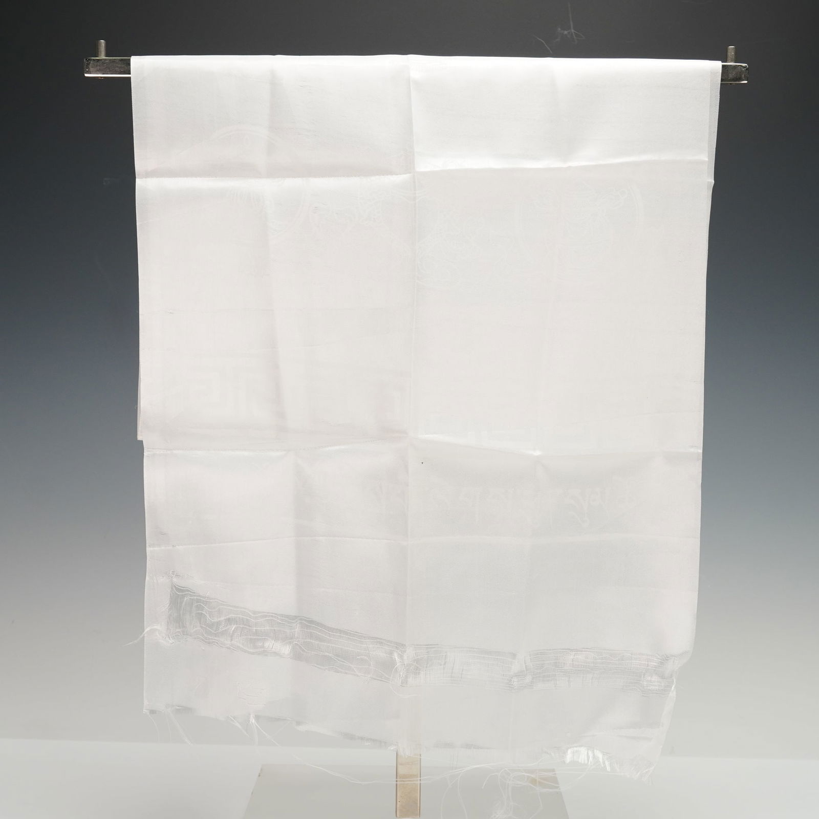 Khata Scarf from the Dalai Lama Visit to FIU September 2004: A traditional white khata scarf presented during the Dalai Lama visit to Florida International University on September 22 2004. The lightweight ceremonial textile has a soft sheen and features woven