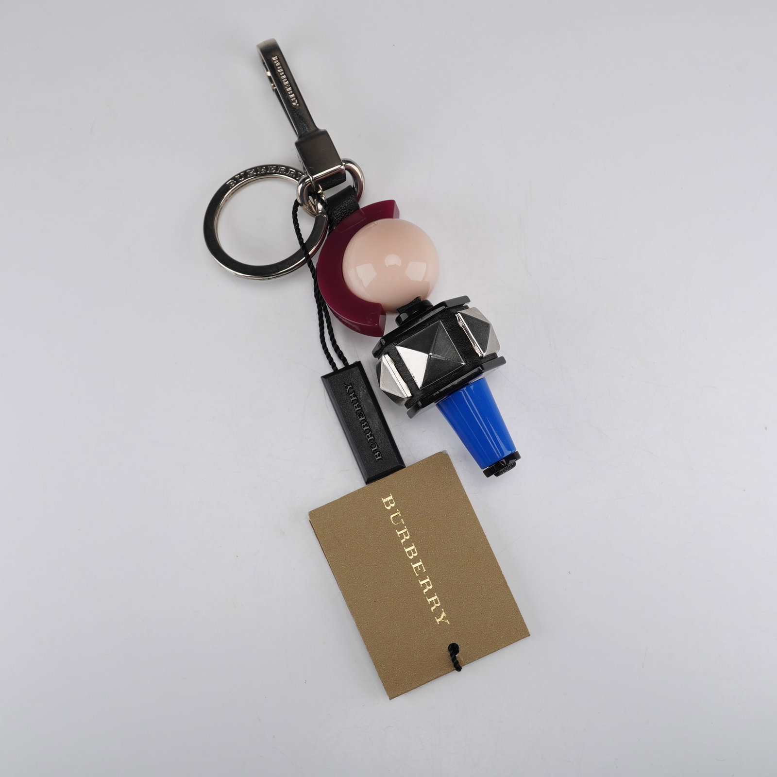 Burberry Punk Geometric Shaped Charm Key Charm NWT: A single Burberry Punk Geometric Shaped Charm Key Charm, often marketed as a bag charm or keychain. The item features an abstract, sculptural assembly of multi-material components, including a large o