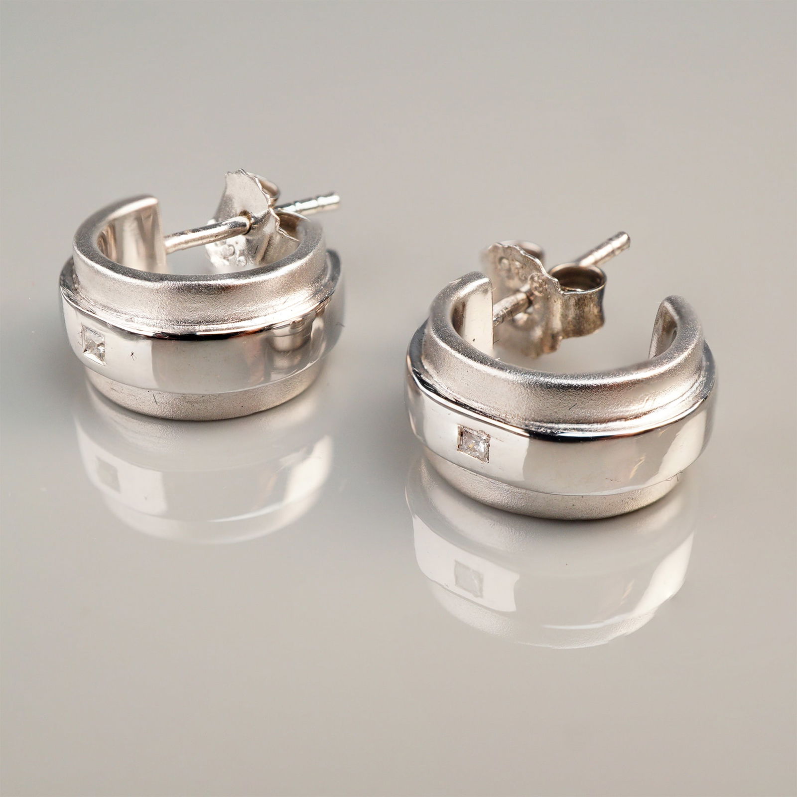 A Pair of Sterling Silver Huggie Hoop Earrings Set with Tested Diamonds (1 of 4)