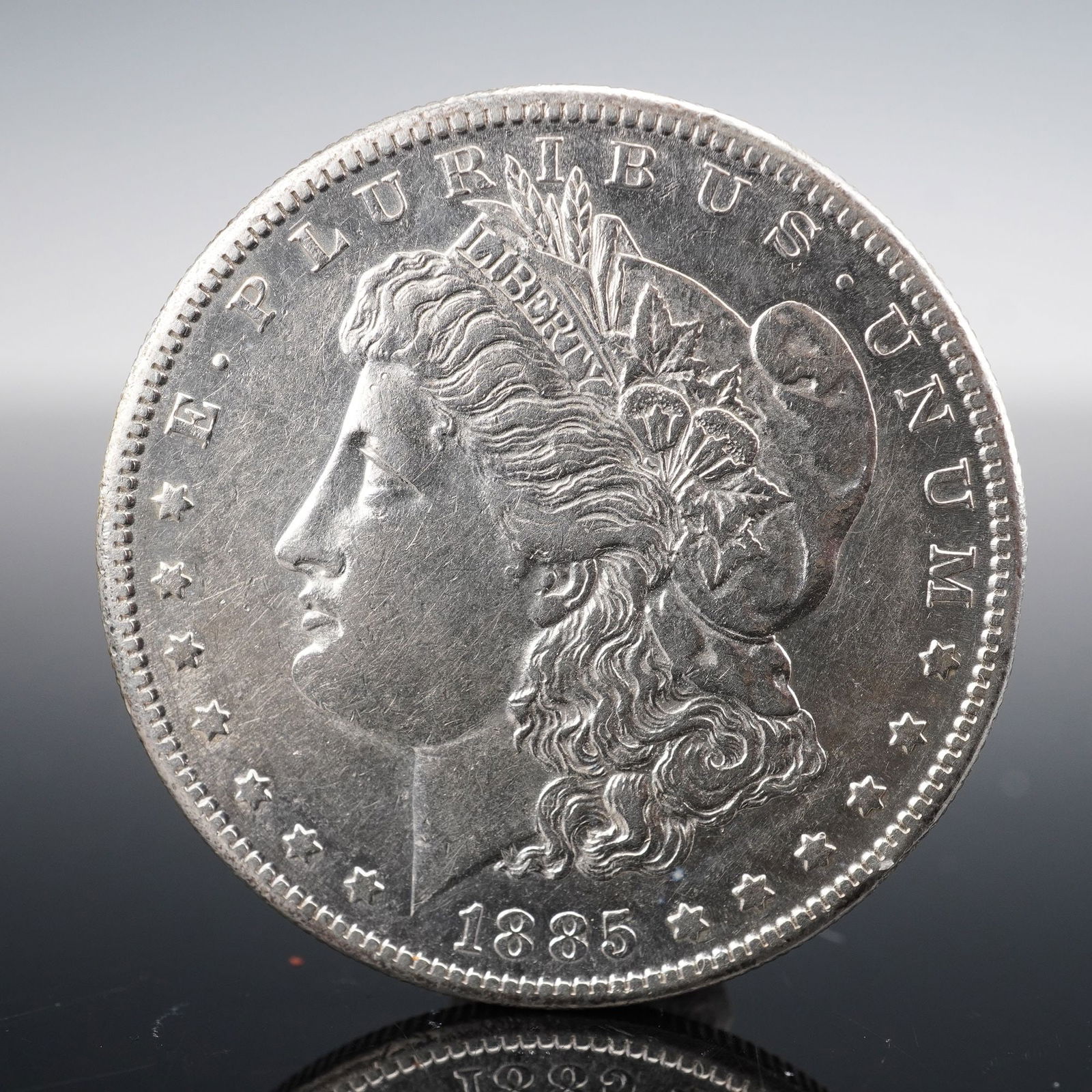 1885-S Morgan Silver Dollar: An 1880-S Morgan Silver Dollar, composed of ninety percent silver, designed by George T. Morgan and struck at the San Francisco Mint. he obverse bears the iconic left-facing profile of Lady Liberty