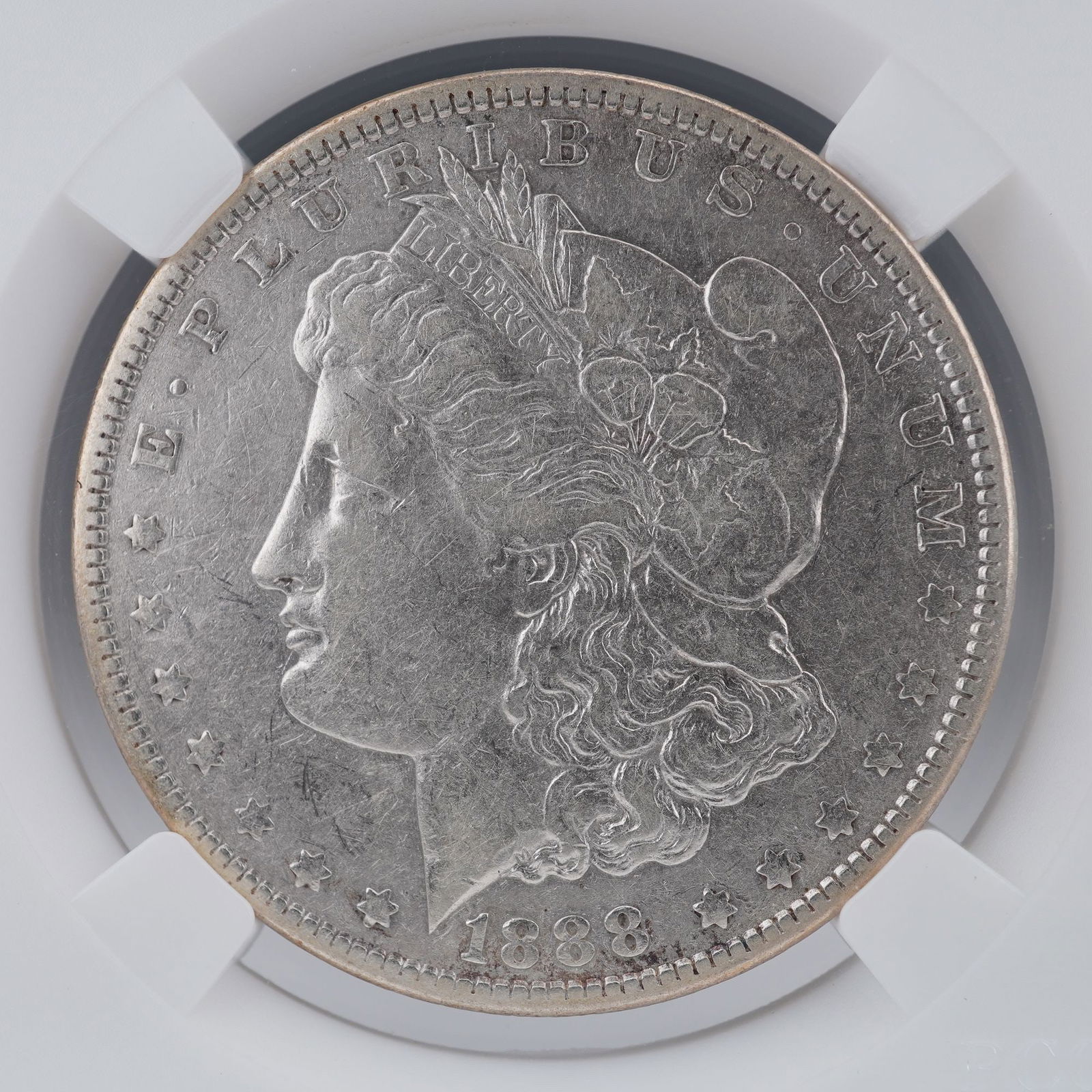 1888 Morgan Silver Dollar: An 1888 Morgan Silver Dollar , composed of 90% silver, designed by George T. Morgan. The obverse bears the classical profile of Liberty adorned with a Phrygian cap and agricultural motifs of wheat