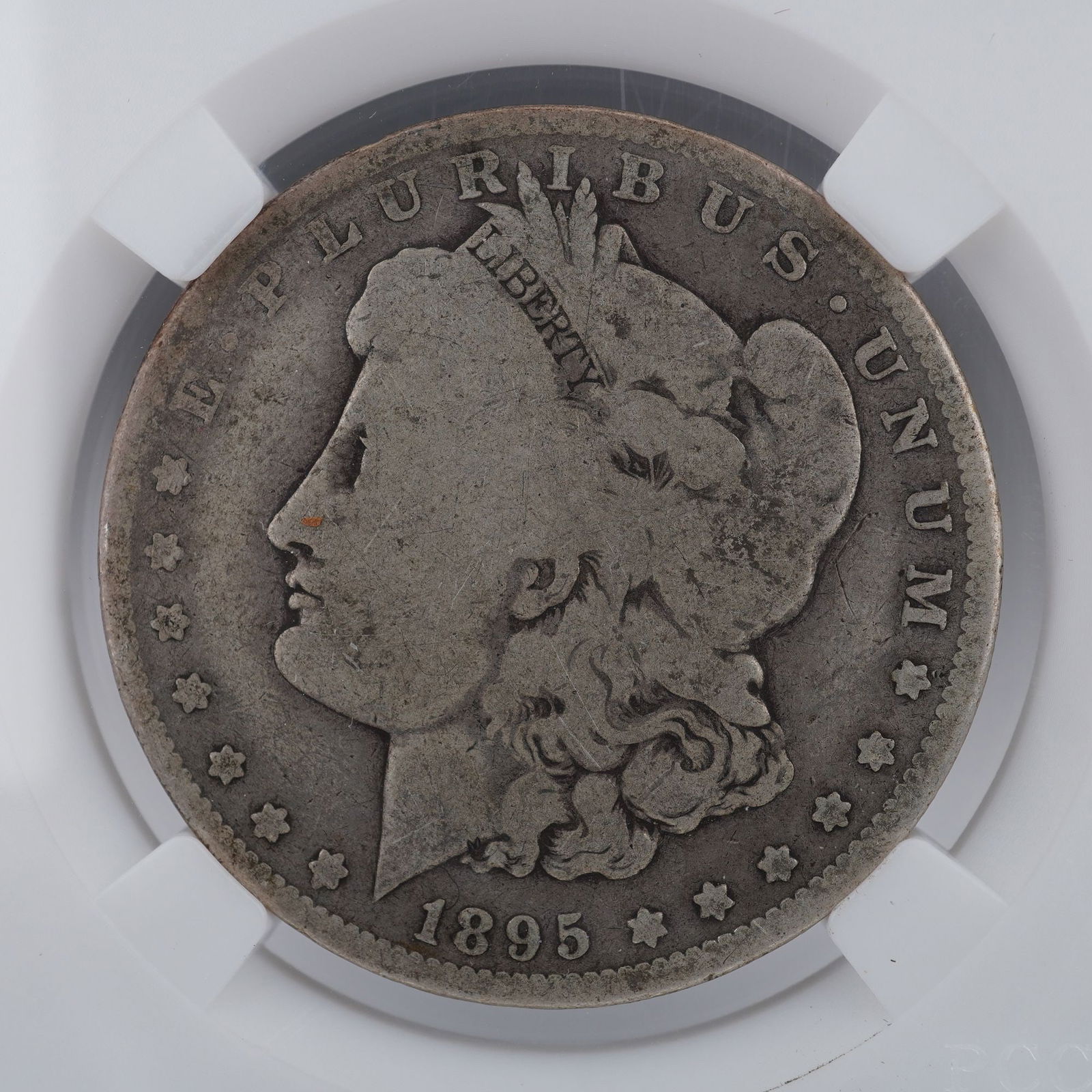 1895-O Morgan Silver Dollar KEY DATE: An 1895-O Morgan Silver Dollar, struck at the New Orleans Mint. he obverse features the classical profile of Lady Liberty wearing a Phrygian cap adorned with cotton and wheat, symbolic of unity and