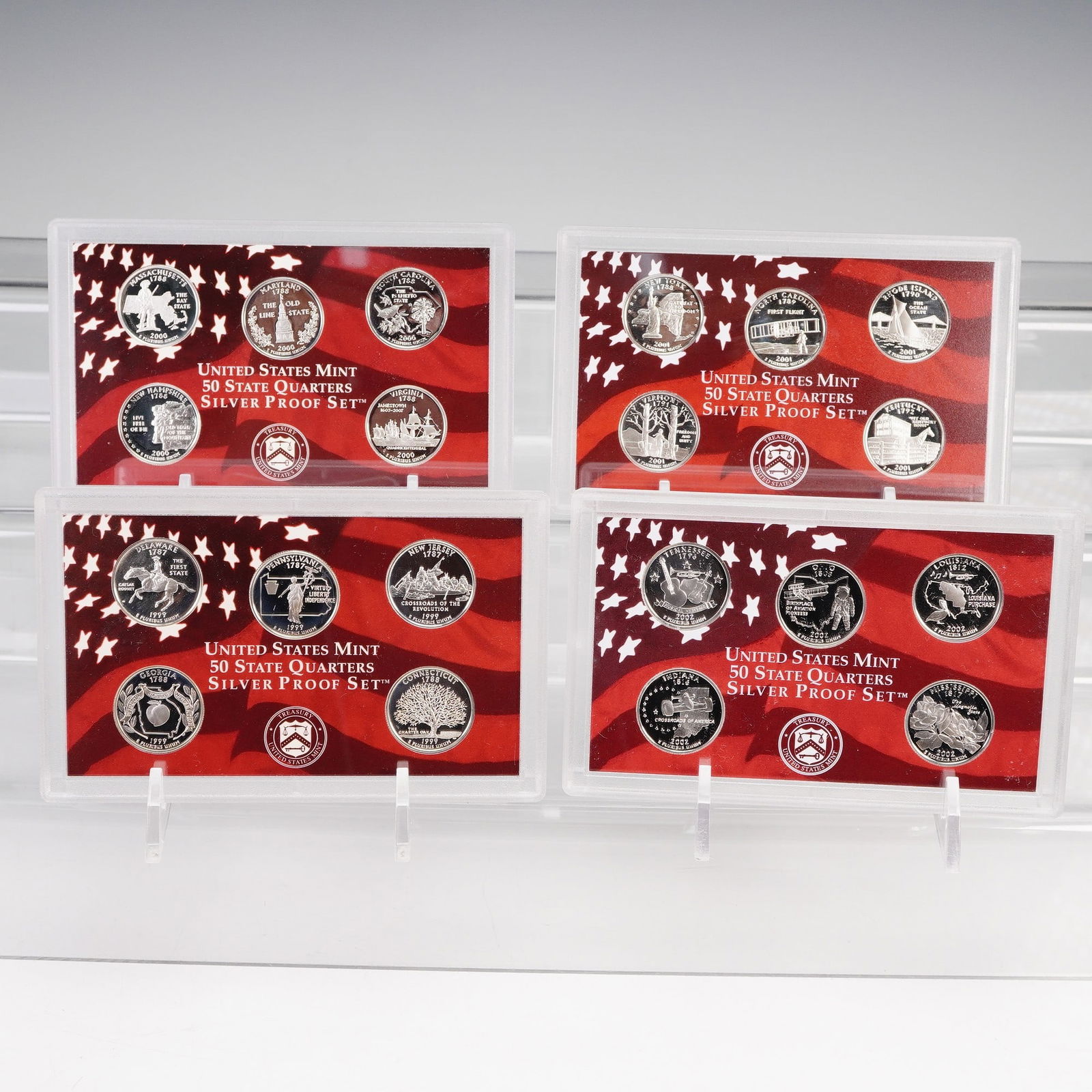 4pc 1999-S to 2002-S United States Mint 50 State Quarters Silver Proof Sets: This group includes the first four years of the United States Mint 50 State Quarters Silver Proof Sets, each struck in 90 percent silver at the San Francisco Mint with the "S" mint mark. The 1999 set