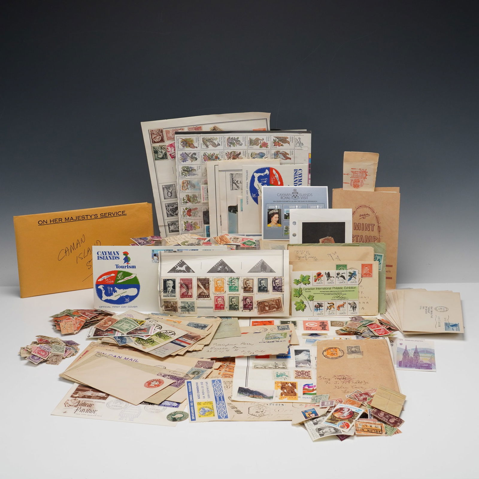 Worldwide Stamp Collection with Covers and First Day Issues: An extensive collection of stamps and related postal materials from around the world, including loose stamps, mounted pages, covers, and first day issues. Countries represented include the United Stat