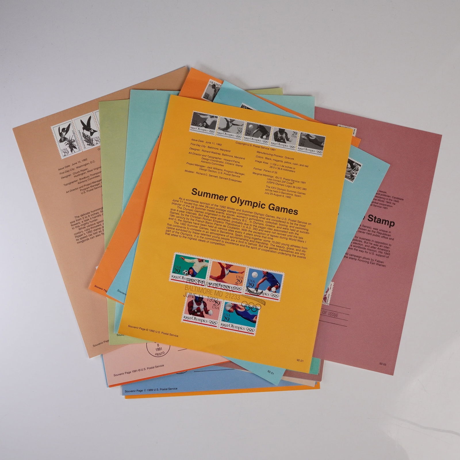 25pc US Postal Service Souvenir Pages with Stamps 1989-1992: A vibrant collection of 25 United States Postal Service souvenir pages, each featuring original stamps and first day of issue cancellations from 1989 through 1992. Highlights include commemoratives fo