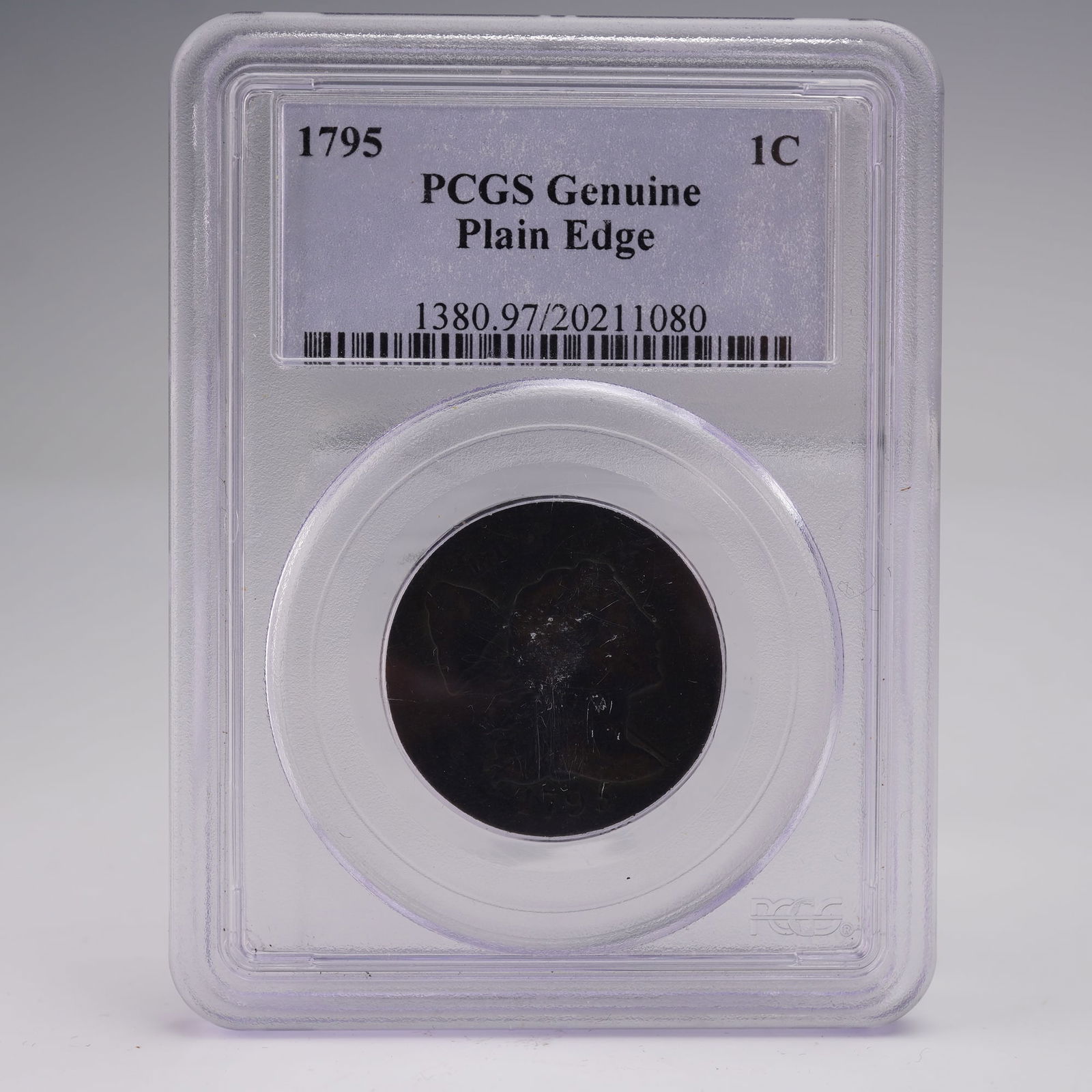 1795 Liberty Cap Large Cent PCGS Graded Genuine Plain Edge: A notable early copper, this 1795 Liberty Cap Large Cent has been authenticated by PCGS as Genuine with a plain edge. The obverse features Liberty facing right, wearing flowing hair with a liberty cap