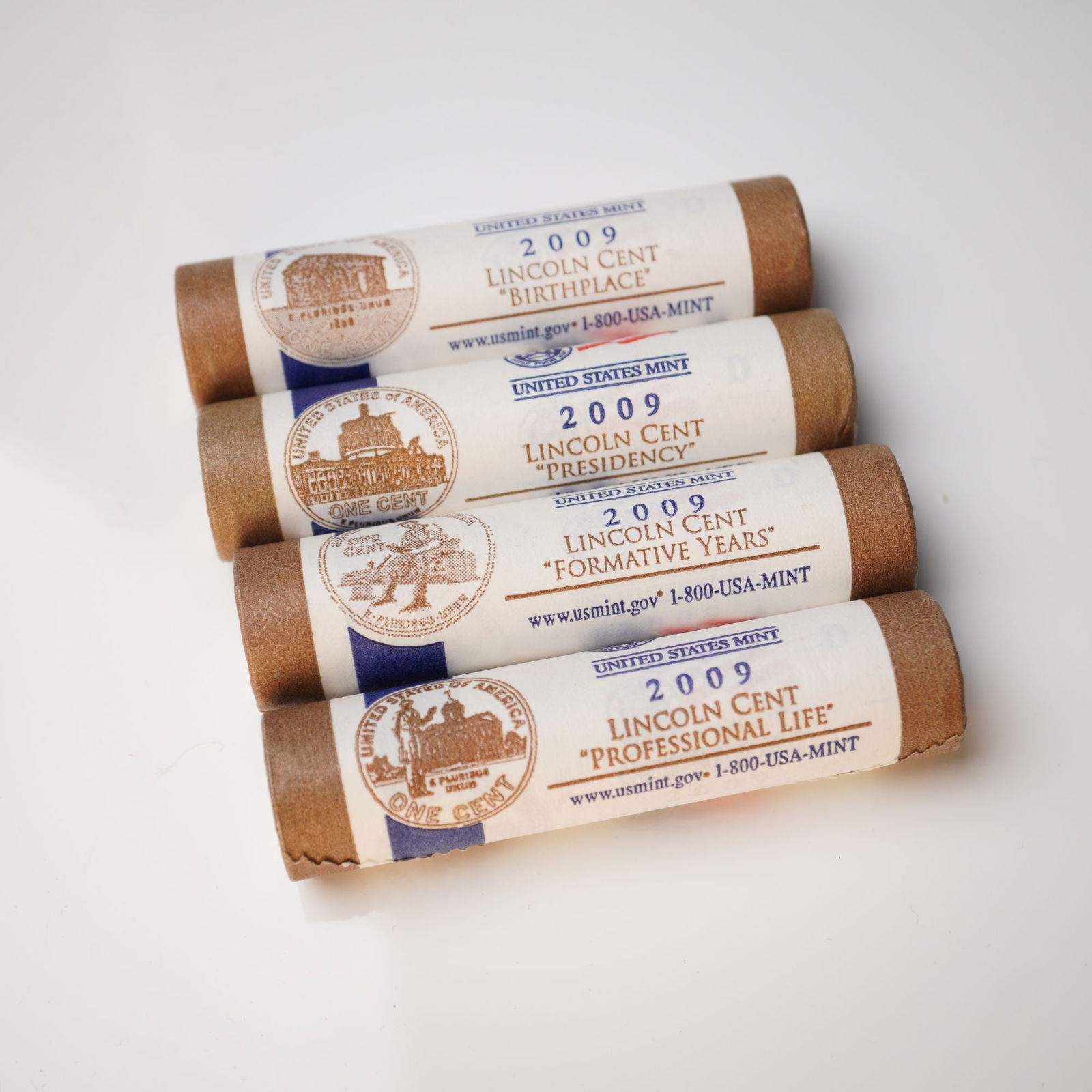 4pc 2009-D Lincoln Cent Commemorative Rolls: Four U.S. Mint rolls of 2009 Lincoln Cents, each featuring a distinct reverse design commemorating stages of Abraham Lincoln's life: Birthplace, Formative Years, Professional Life, and Presidency. Eac