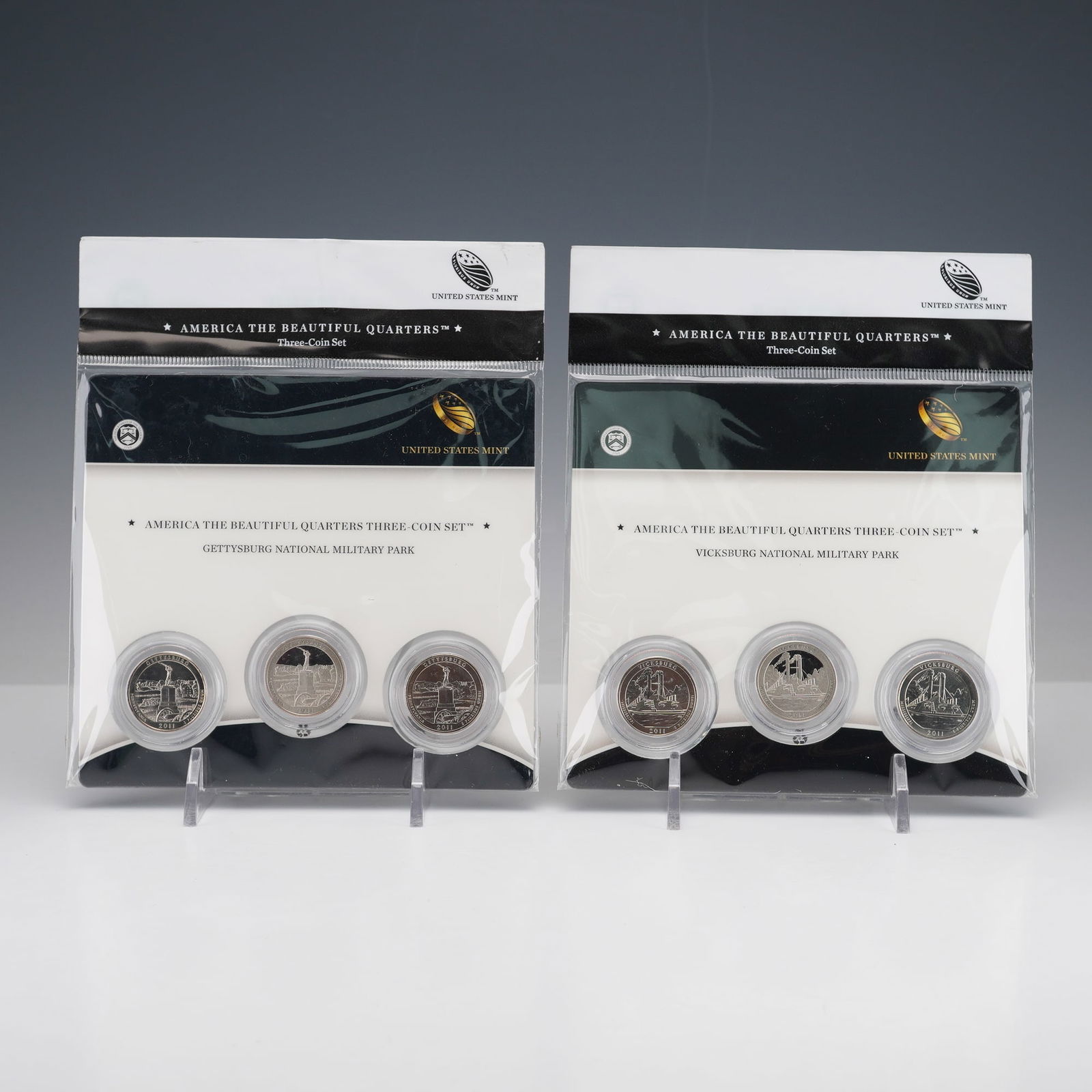 2pc 2011 America the Beautiful Three-Coin Quarters Sets: America the Beautiful Quarters three-coin sets from 2011, featuring Gettysburg National Military Park and Vicksburg National Military Park. Each set includes an uncirculated quarter from the Philadelp