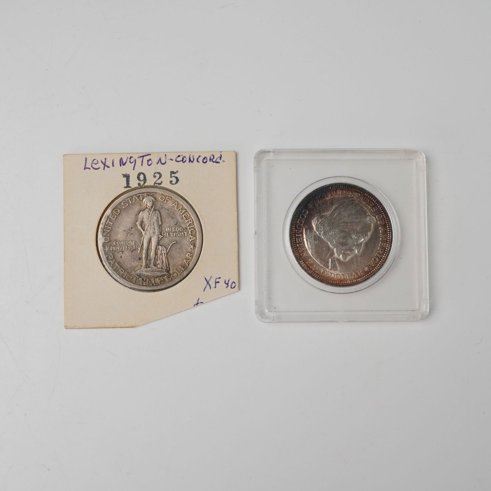 2pc 1893 & 1925 United States Commemorative Half Dollar Coins: Features an 1893 Columbian Exposition issue struck to honor the 400th anniversary of Columbus' voyage, displaying the explorer's portrait and a detailed depiction of his flagship alongside hemispheric