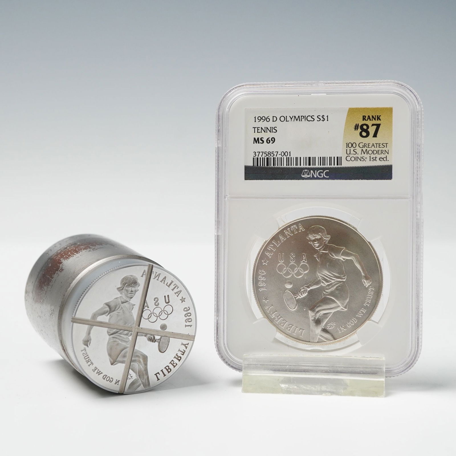 2pc 1996-D Olympics Silver Dollar NGC Graded MS 69 with Coin Die: A 1996-D Atlanta Centennial Olympic Games Commemorative Silver Dollar, bearing the Tennis design, authenticated and encapsulated by the Numismatic Guaranty Corporation. The obverse depicts a woman pla