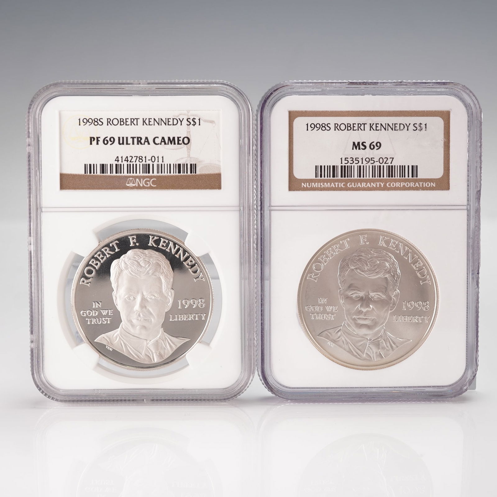 2pc 1998-S Robert F. Kennedy "Justice" Commemorative Silver Dollars Coins: A pair of 1998-S Robert F. Kennedy Commemorative Silver Dollars. Each coin is encapsulated by Numismatic Guaranty Corporation (NGC). The left coin is graded PF 69 ULTRA CAMEO with serial 4142781-011,