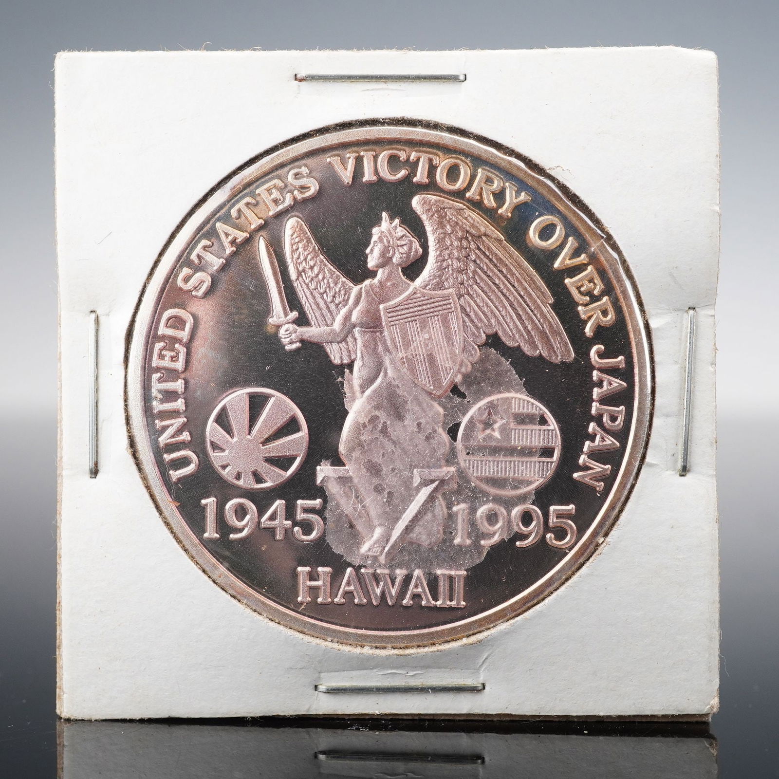 1995 Hawaii United States Victory Over Japan Silver Memorial Coin: A 1995 Hawaii commemorative silver coin marking the 50th anniversary of the United States victory over Japan at the end of World War II. The obverse features a winged Victory figure holding a sword an
