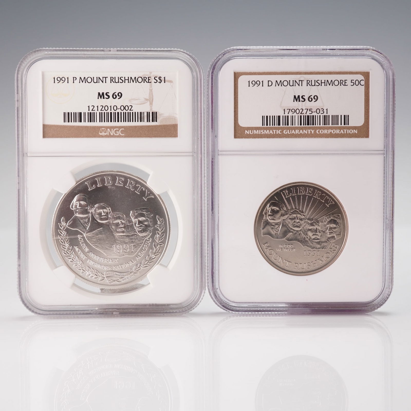 2pc 1991 Mount Rushmore Commemorative Coins, Graded NGC MS 69: A pair of modern United States commemorative coins, each individually encapsulated in a clear, sonically sealed plastic holder by the Numismatic Guaranty Corporation (NGC). The larger coin is a 1991 P