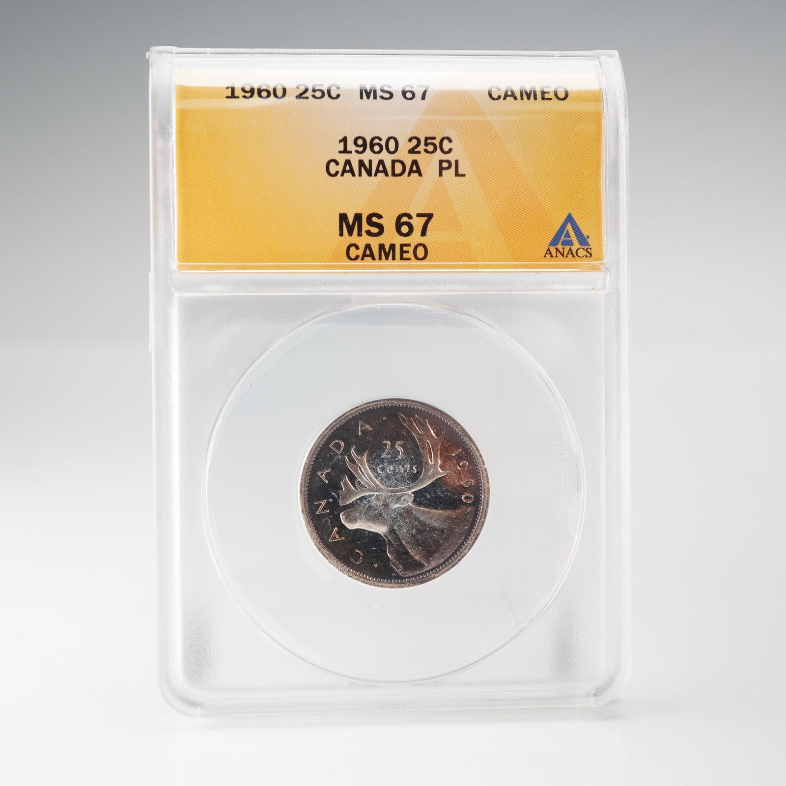 1960 Canada 25 Cent Coin, ANACS MS67 Cameo: This 1960 Canadian 25-cent coin, graded MS67 Cameo by ANACS, features the caribou design by Emanuel Hahn and the young effigy of Queen Elizabeth II by Mary Gillick. It displays exceptional prooflike s