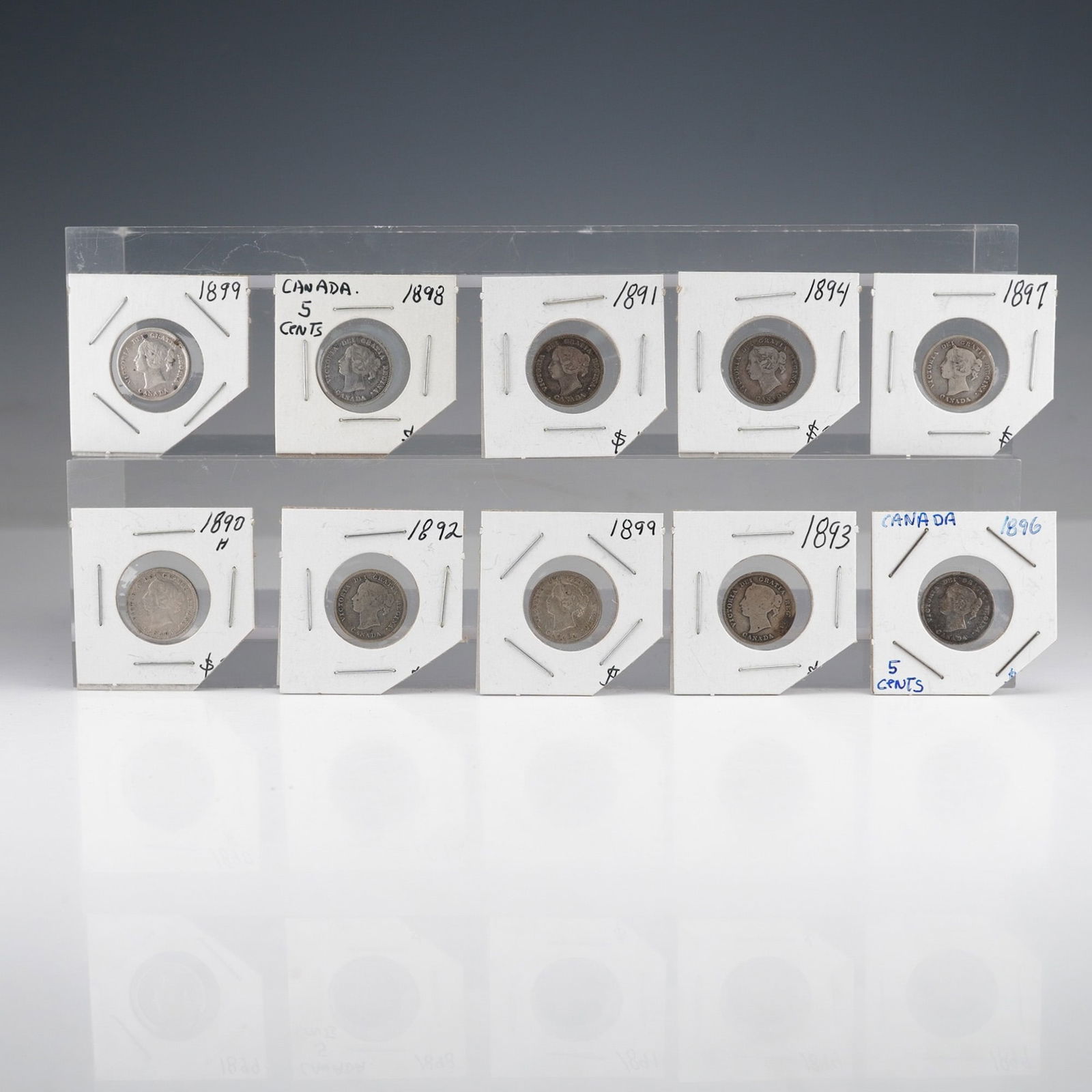 10pc Late 19th Century Canadian Queen Victoria Silver 5-Cent: A collection of ten late 19th-century Canadian 5-cent coins, each featuring a portrait of Queen Victoria on the obverse with the legend "VICTORIA DEI GRATIA REGINA" and "CANADA" below the portrait. Th
