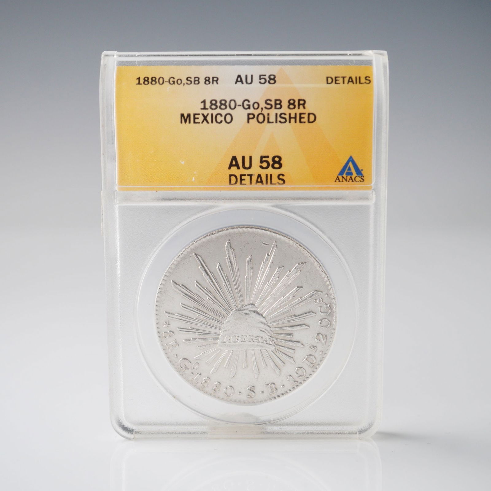 1880-Go SB Mexico 8 Reales Silver Coin ANACS Graded AU 58 POLISHED: An 1880-Go SB Mexican 8 Reales silver coin, graded by ANACS as AU58 Details with the notation "Polished." Struck at the Guanajuato Mint, the obverse features the radiant Liberty cap inscribed Libertad