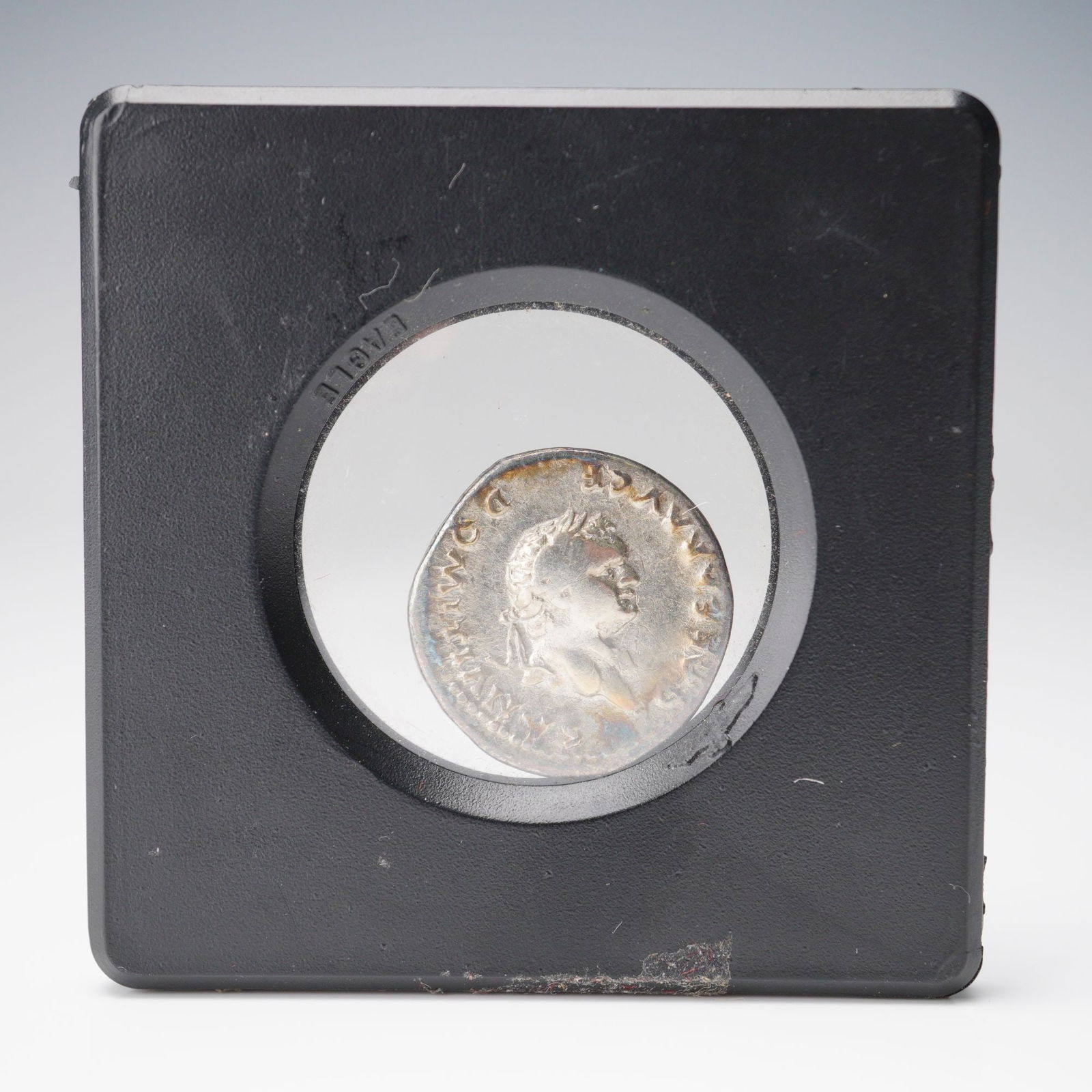 81-96 AD Roman Coin Domitian Denarius Boar Reverse: This Roman denarius features Emperor Domitian on the obverse, with a detailed bust of the emperor wearing a laurel wreath. The reverse depicts a bull facing left, with two children seated beneath it,