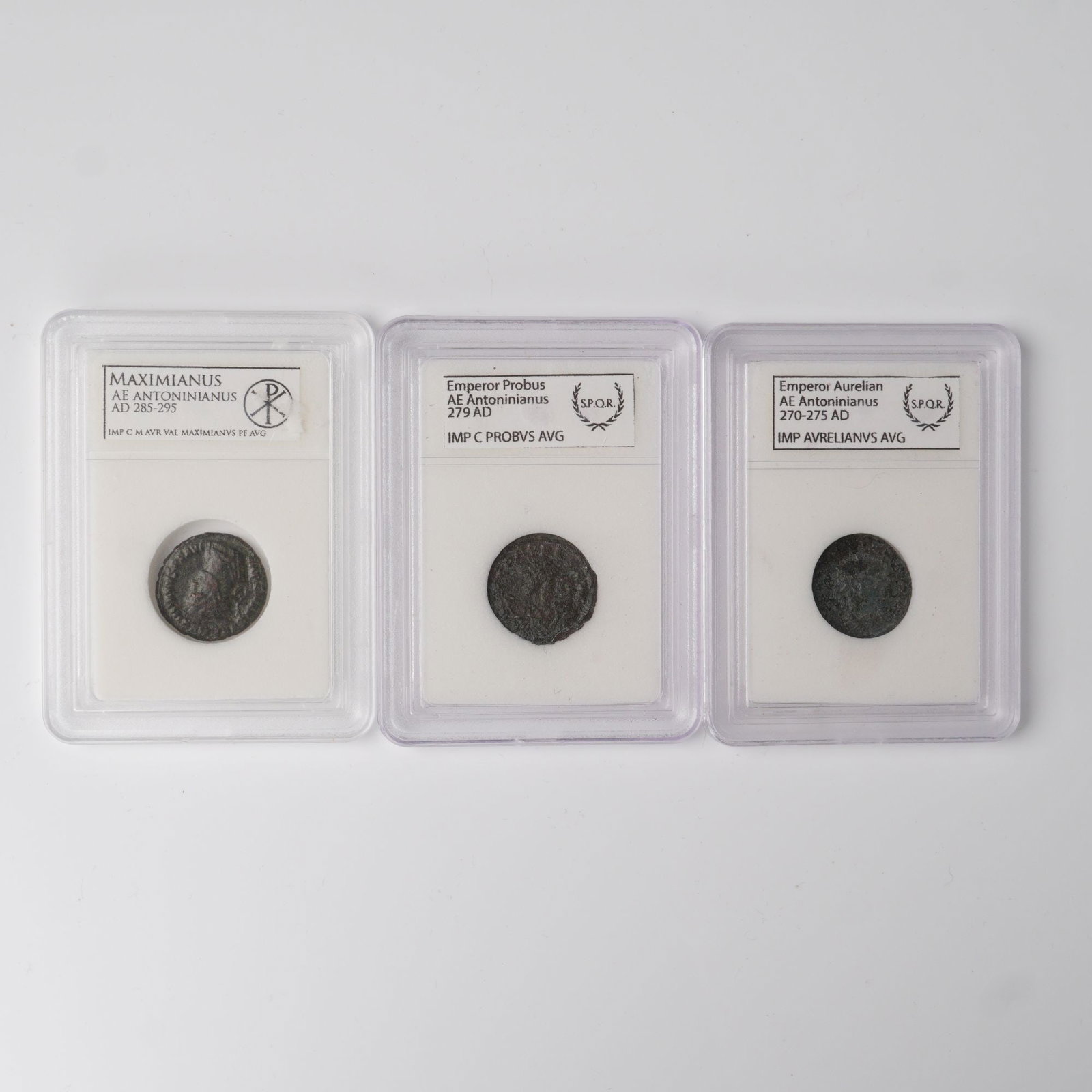 3pc Ancient Roman Imperial AE Antoninianus Coins: Three Late 3rd Century AD Ancient Roman AE Antoninianus coins, each encapsulated with identification details. The collection features an issue of Emperor Aurelian (AD 270-275) with obverse legend IMP 