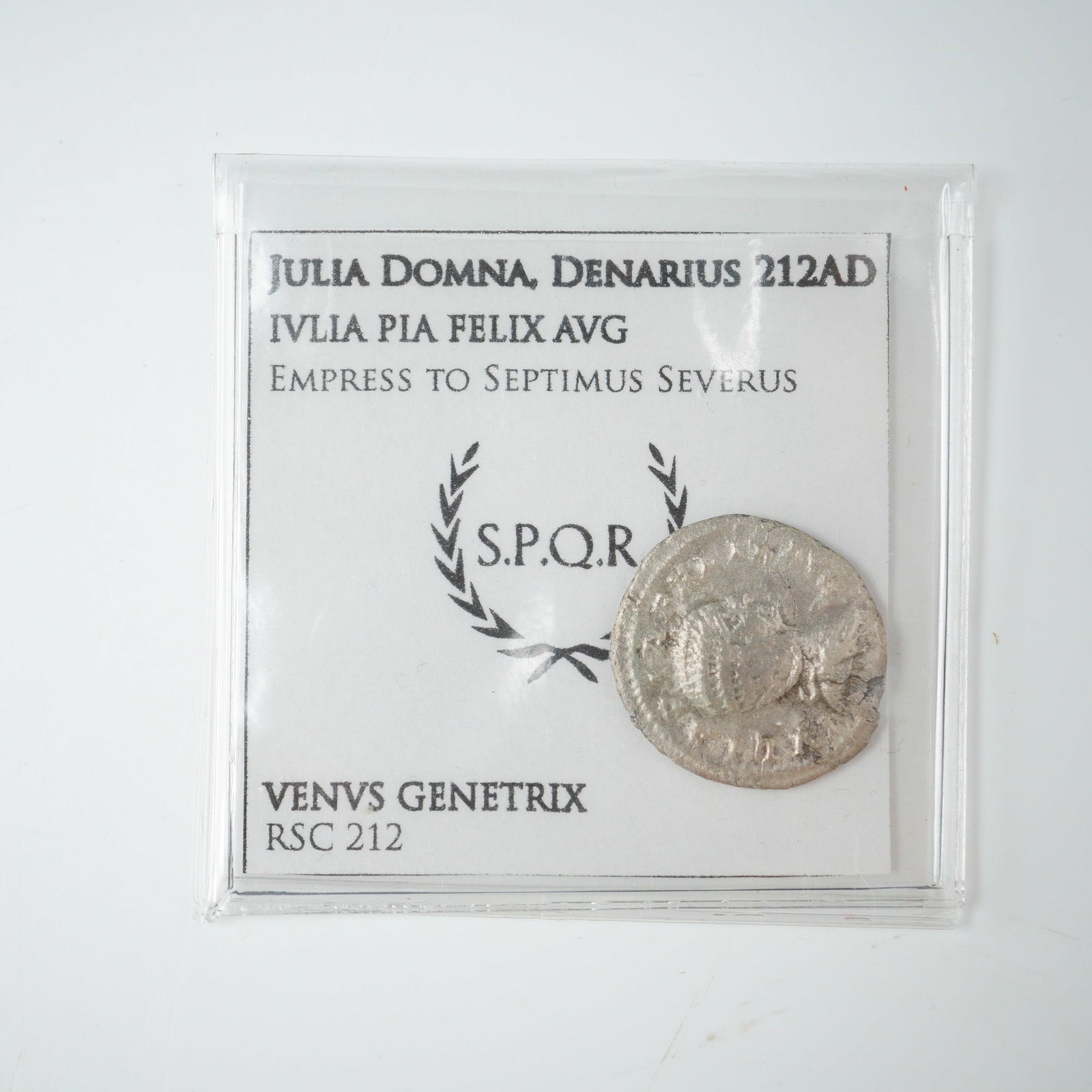 Ancient Julia Domna Silver Denarius Coin: Struck in Rome, this silver denarius honors Julia Domna, wife of Emperor Septimius Severus and mother of Caracalla and Geta. The obverse features the draped bust of Julia Domna facing right with the i