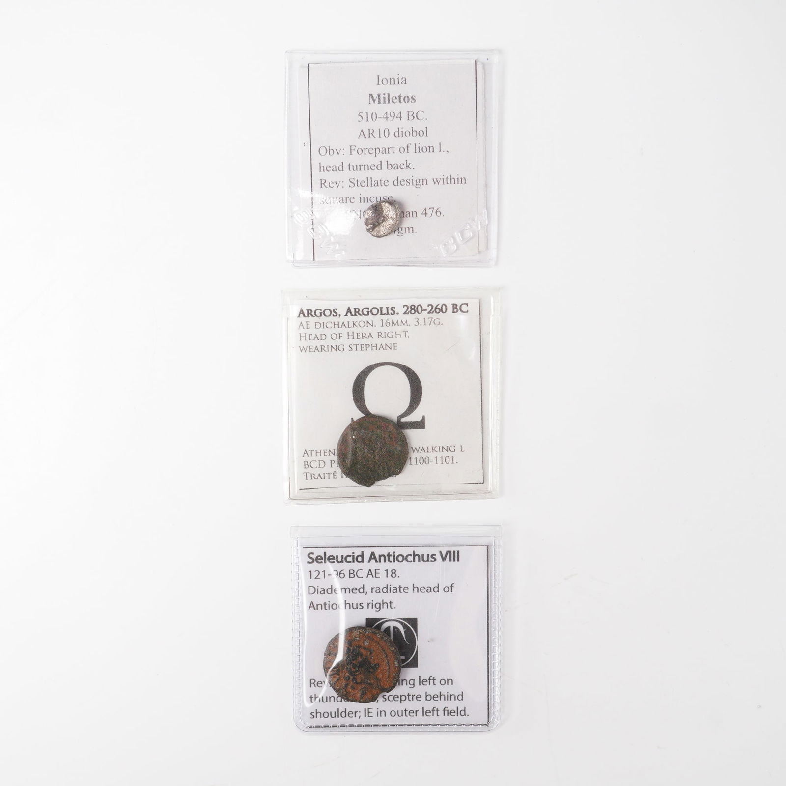 3pc Ancient Greek Bronze and Silver Coins: The first, from Ionia, Miletos (510-494 BC), is an AR10 diobol of silver content, featuring on the obverse the forepart of a lion left with head turned back, and on the reverse a stellate design withi