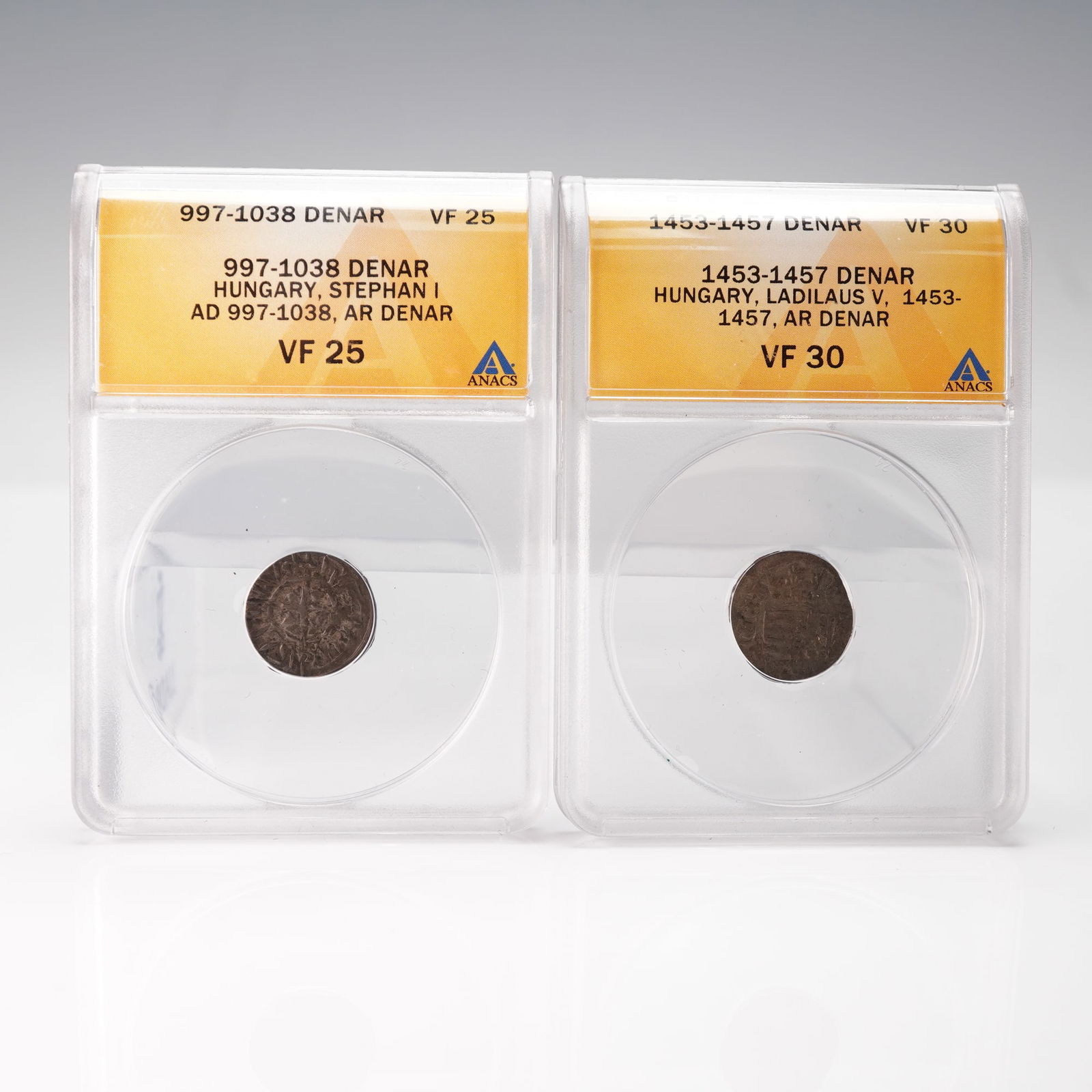 2pc HU Medieval Denar Coins, Stephan I & Ladislaus V, AR, ANACS VF 25/30: This 2pc group features two medieval Hungarian silver denars, each slabbed and authenticated by ANACS. The first coin is a silver denar struck under King Stephan I (AD 997-1038). The second coin is a