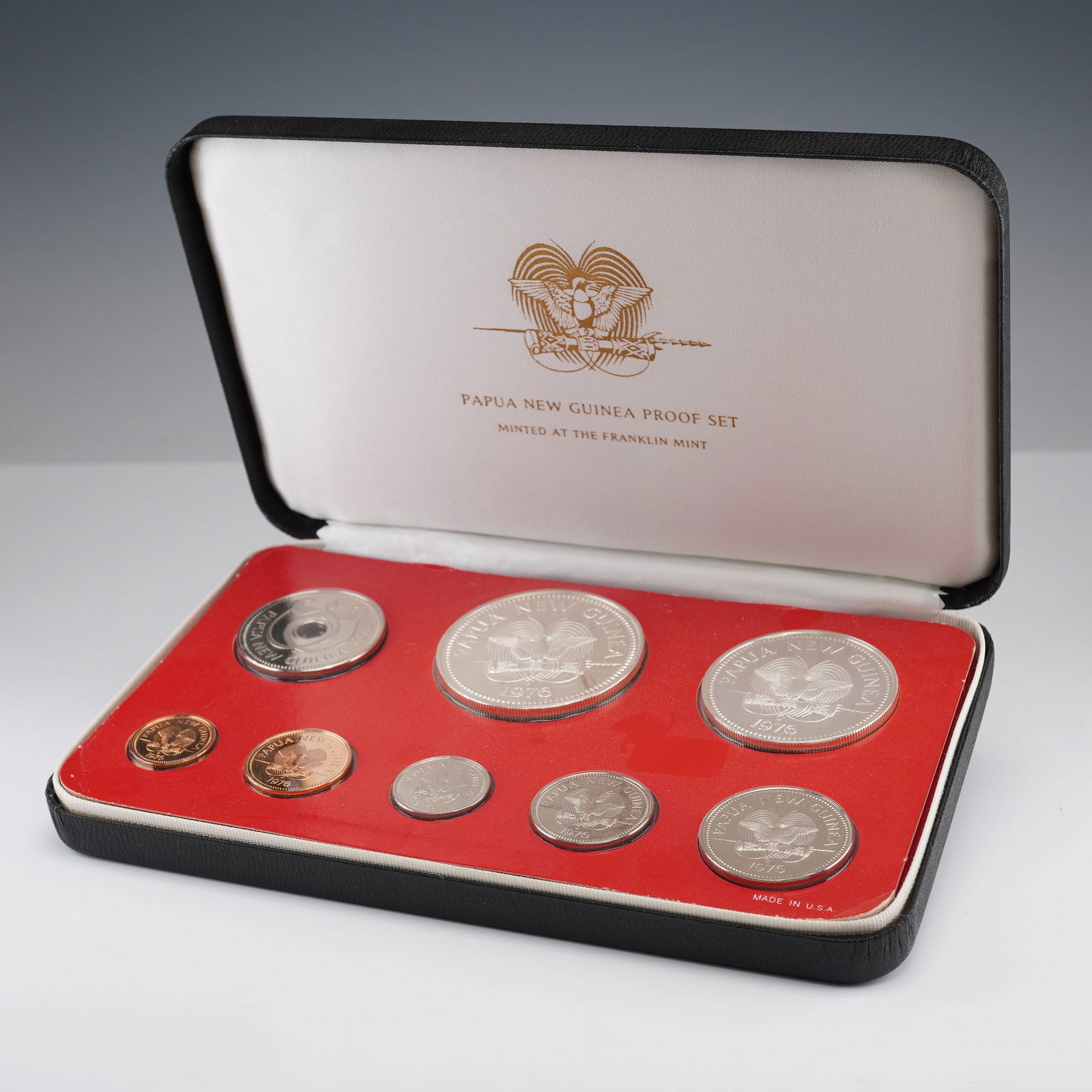 1976 Papua New Guinea Proof Coin Set: This 8-piece 1976 proof set was minted by The Franklin Mint under authorization of the Government of Papua New Guinea. Issued during the early years of the nation's independence, the set celebrates th