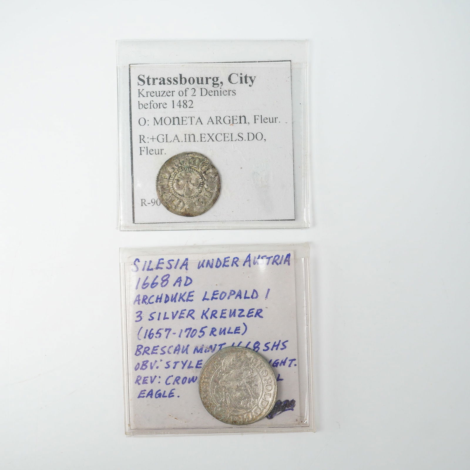 2pc 1482 to 1688 Kreuzer Coins: Featuring a Strassbourg, City, Kreuzer of 2 Deniers struck before 1482. The obverse bears the inscription MONETA ARGEN with a floral design, while the reverse reads GLA.IN.EXCELS.DO, also featuring a