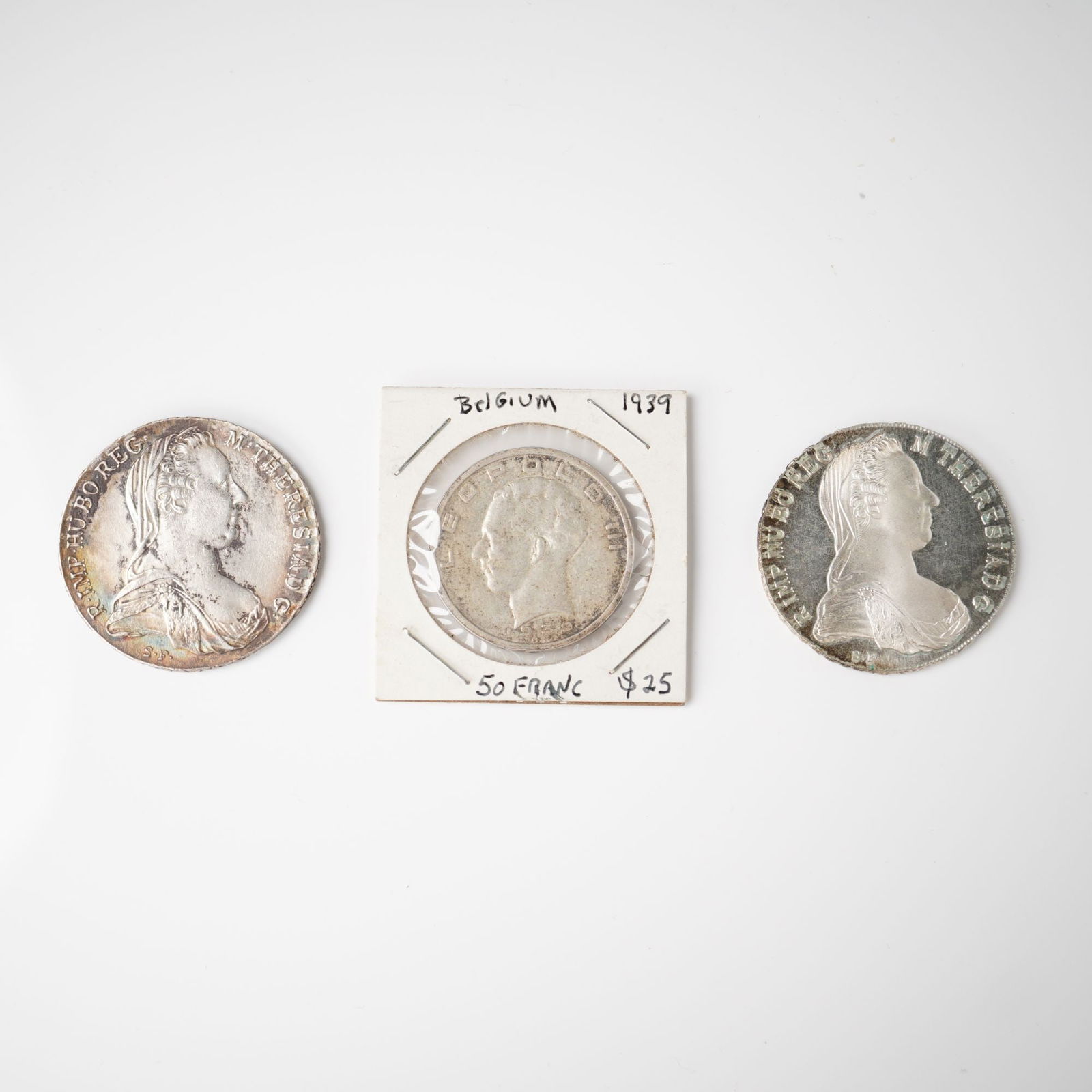 3pc Belgian 50 Franc & Austrian Maria Theresa Coins: The first is a Belgian 50 Franc coin dated 1939 featuring King Leopold III on the obverse with the inscription LEOPOLD III and the reverse depicting a crowned grouping of provincial coats of arms with