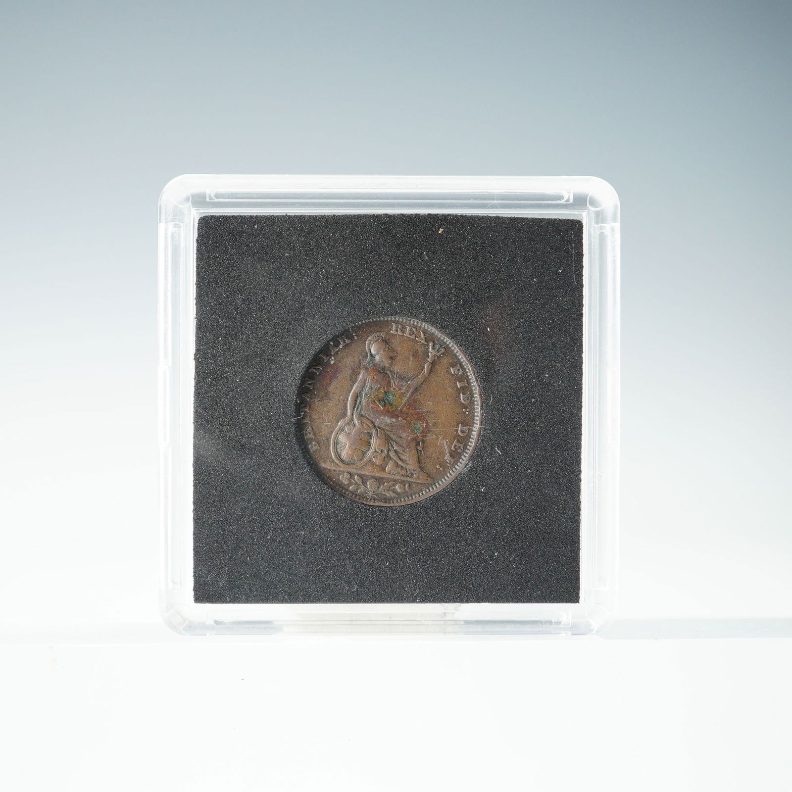 1827 George IV British Farthing Coin: This 1827 George IV 1 Farthing coin features a laureate portrait of King George IV facing left, with the inscription GEORGIUS IV DEI GRATIA and the date 1827. The reverse depicts a seated Britannia fa