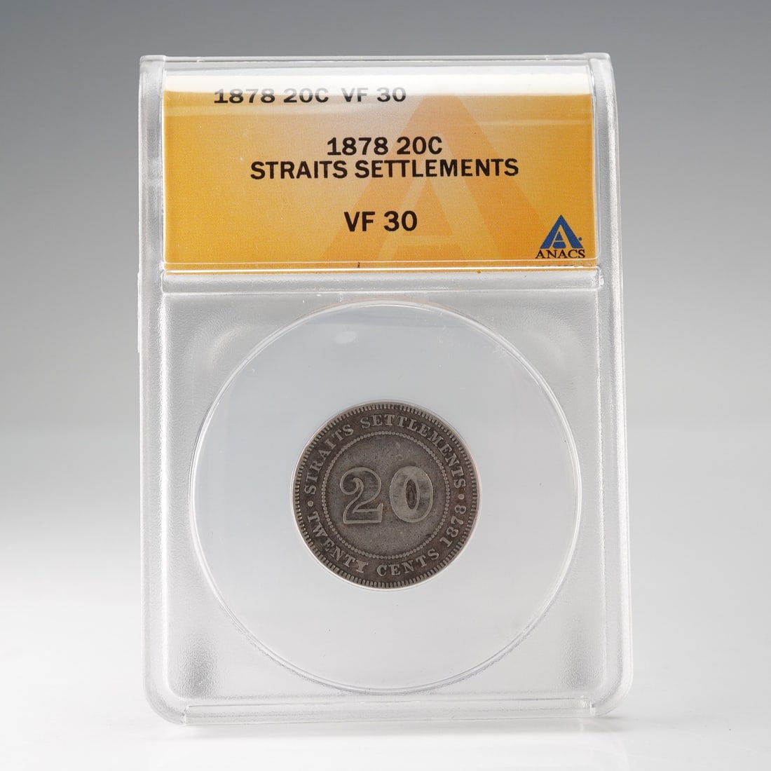 1878 Straits Settlements 20 Cents ANACS Graded VF 30: Silver twenty-cent coin from the Straits Settlements, dated 1878, graded VF30 by ANACS. The obverse features the crowned bust of Queen Victoria facing left, with the legend VICTORIA QUEEN, designed by