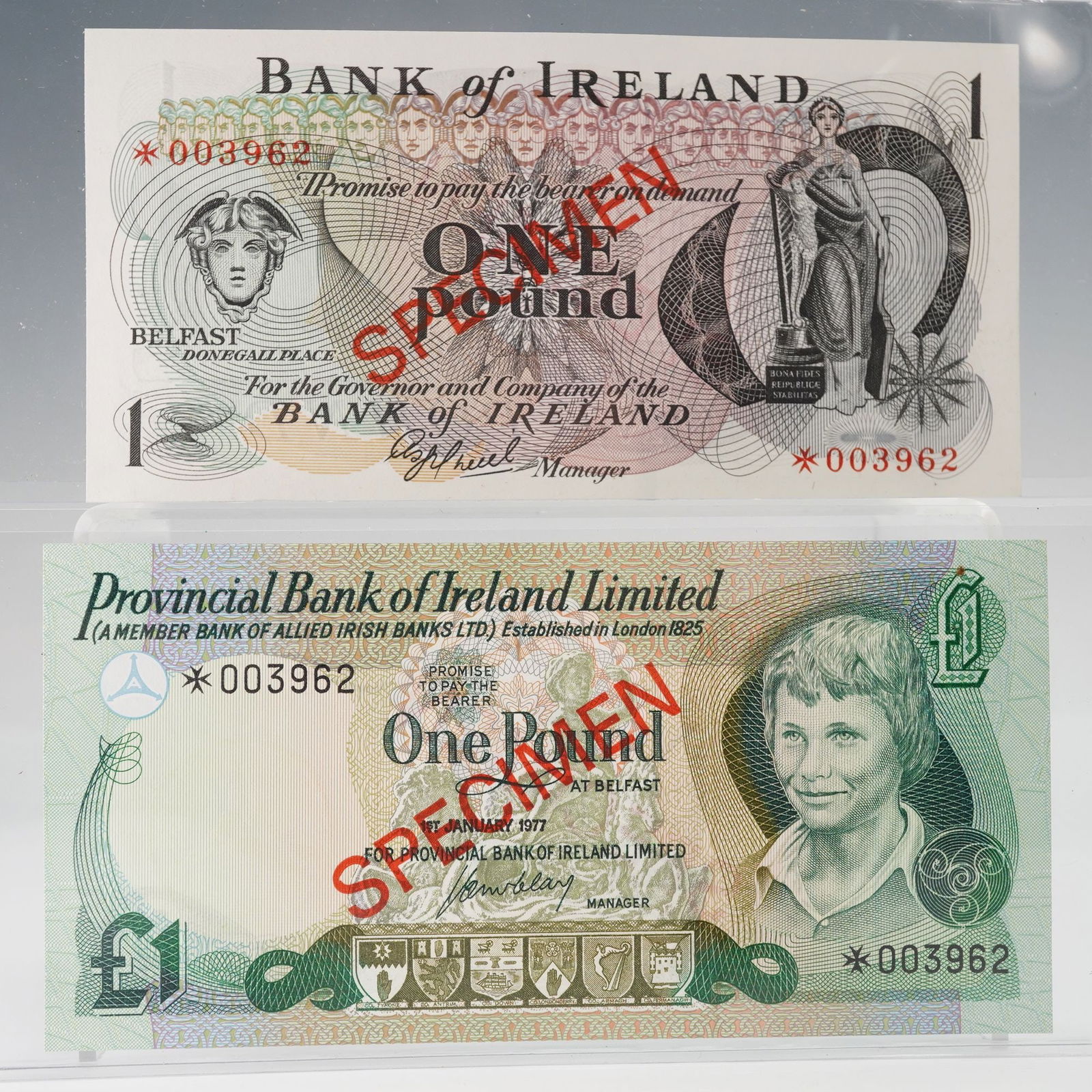 2pc 1977 Provincial Bank & ND Bank of Ireland One Pound Specimen Notes: Pair of Irish One Pound Specimen banknotes, comprising a 1977 Provincial Bank of Ireland Limited issue and an undated Bank of Ireland issue. The Provincial Bank note features a portrait of a young boy