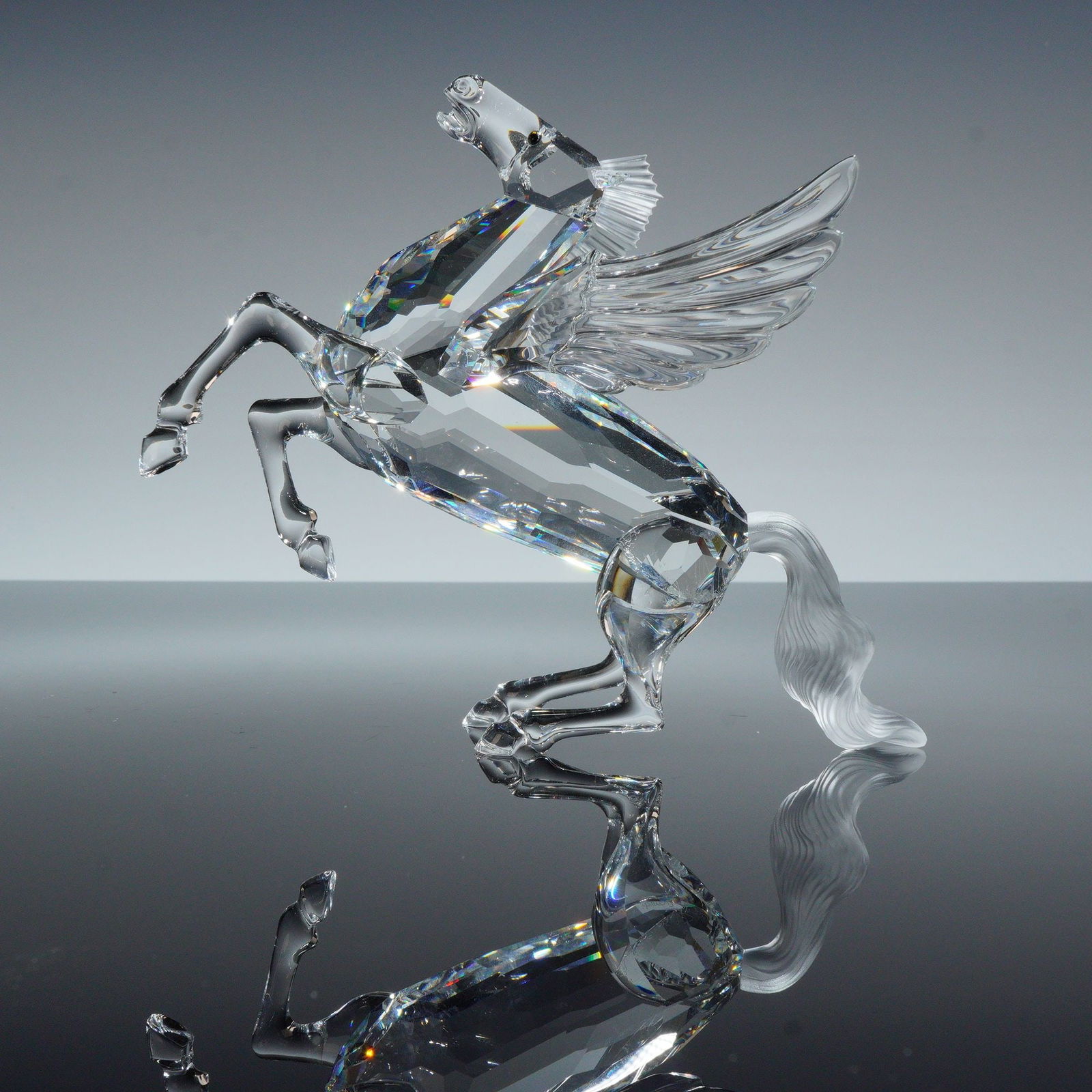 Swarovski Crystal Figurine, Pegasus 216327: This Swarovski crystal figurine depicts the Pegasus from the Fabulous Creatures series, issued as an Annual Edition. The piece is constructed from clear faceted lead crystal in a rearing pose. The