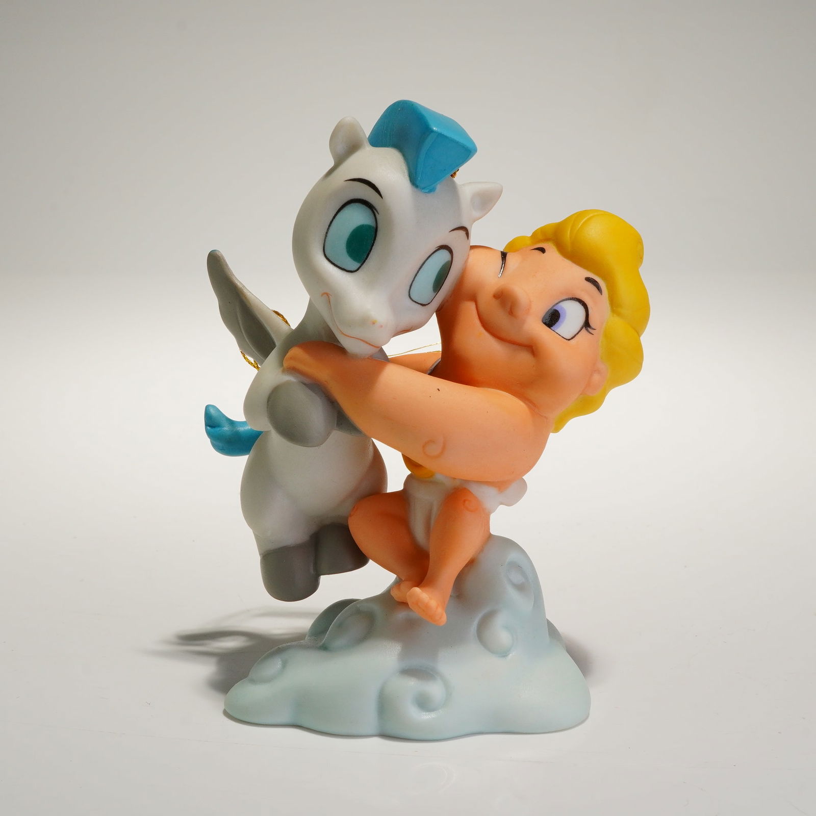 Walt Disney Classics Coll. Baby Hercules and Baby Pegasus Ornament w/ COA: A collectible ornament from the Walt Disney Classics Collection (WDCC), titled "Baby Hercules & Baby Pegasus: A Gift from the Gods." The piece is crafted from painted porcelain and depicts the two